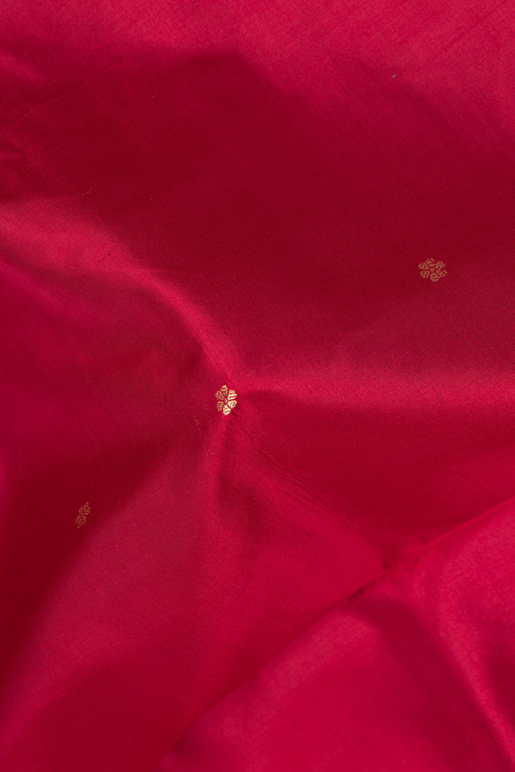 Close up of Maroon Banarasi Katan Silk Saree with Zari Butta on the body and Zari Border.  displaying folds