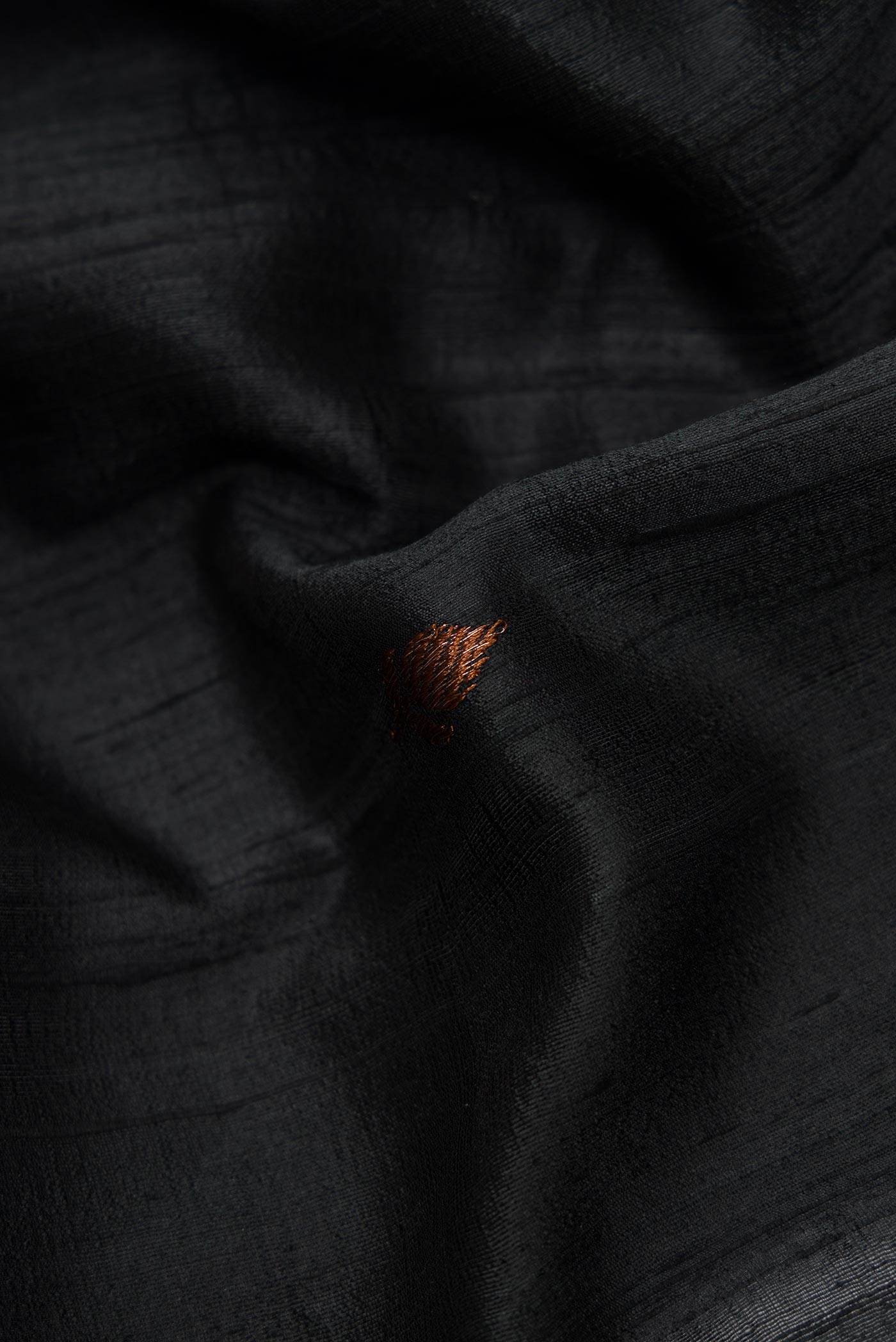 Close up of Black Banarasi Tussar Silk Saree with Zari Butta on the body and Without Border displaying folds