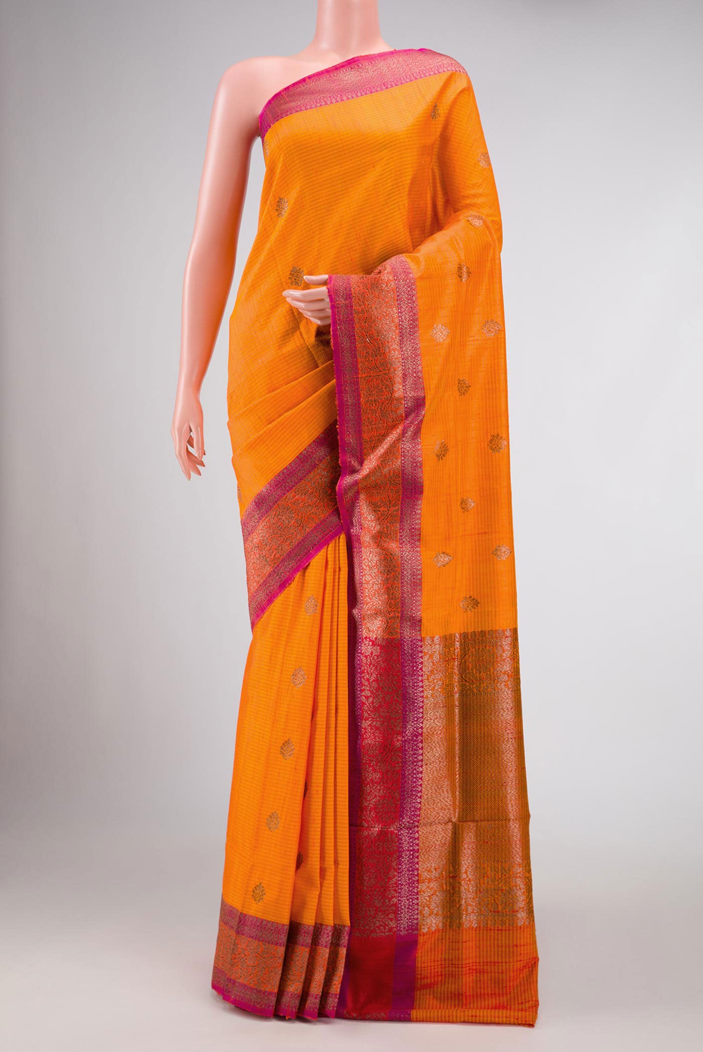 Orange Banarasi Tussar Silk Saree with Zari Butta on the body and Zari Border displayed on a mannequin