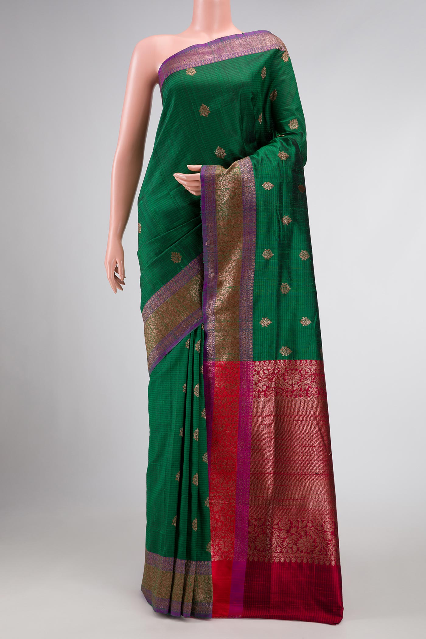 Bottle Green Banarasi Tussar Silk Saree with Zari Butta on the body and Zari Border displayed on a mannequin