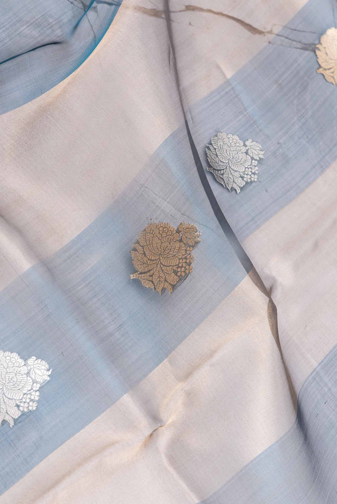 Close up of Peacock Blue Dual Tone Organza Silk Saree with Stripes on the body and Without Border displaying folds