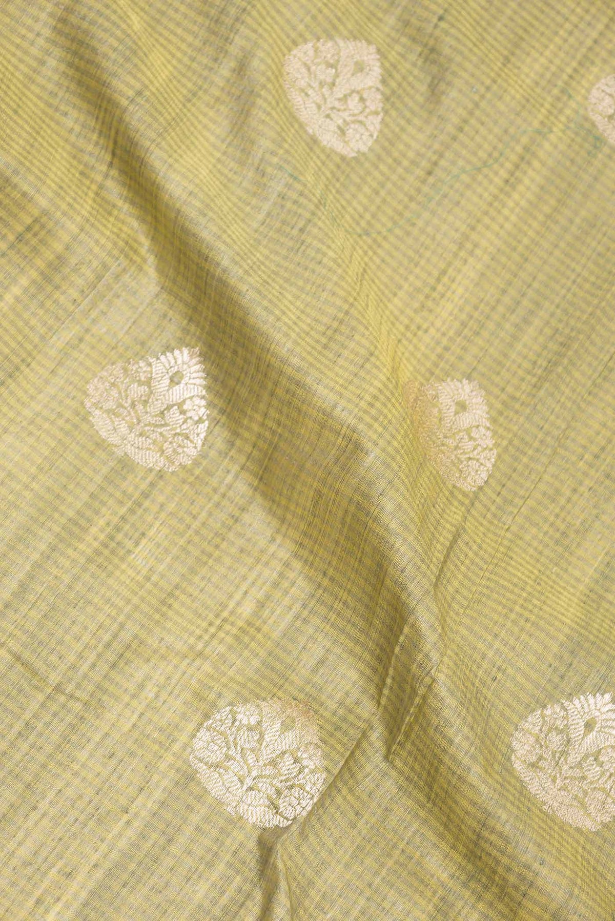 Close up of Pista Green Dual Tone Banarasi Silk Saree with Zari Butta on the body and Zari Border displaying folds