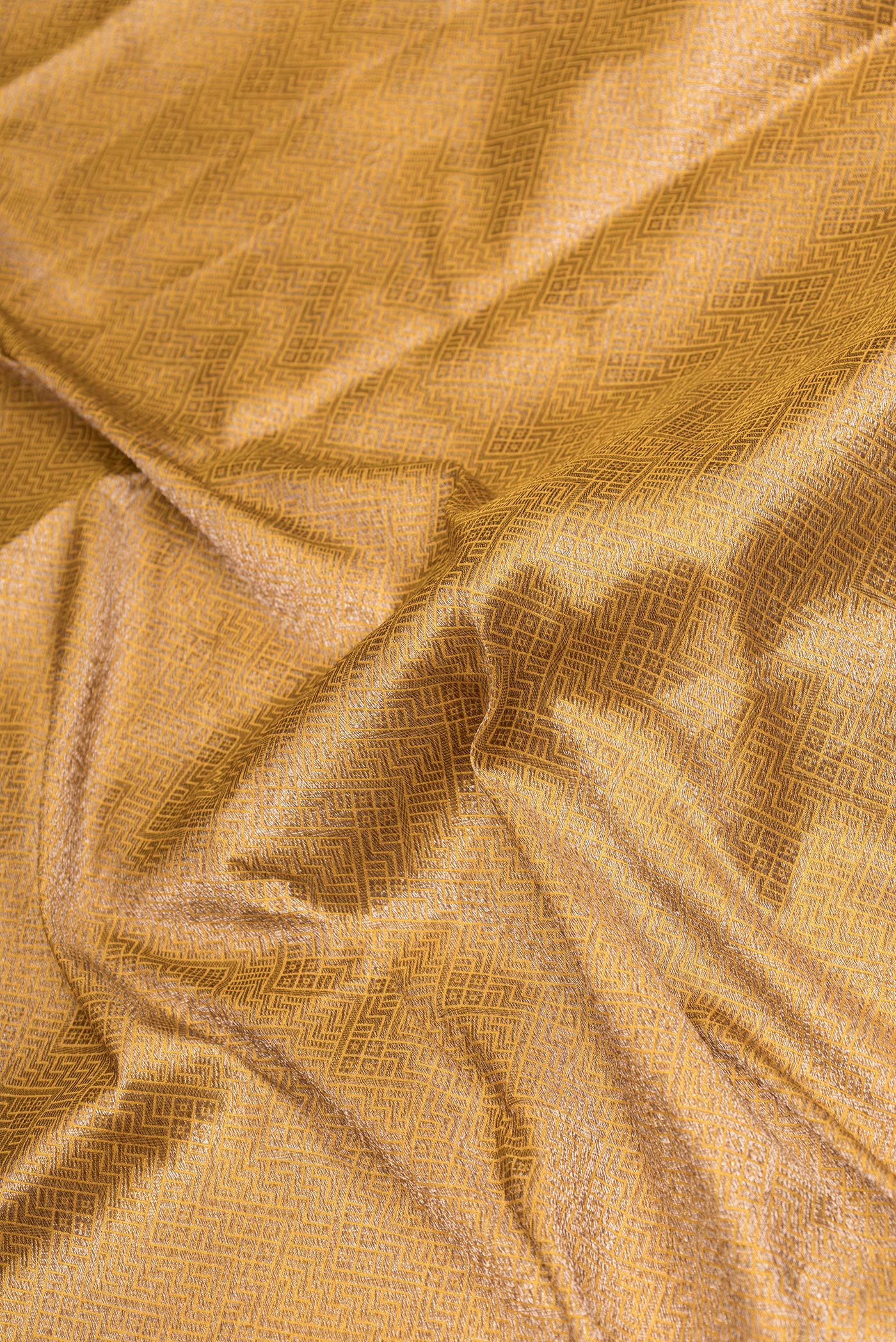 Close up of Yellow Dual Tone Banarasi Silk Saree with Zari Brocade on the body and Zari Border.  displaying folds
