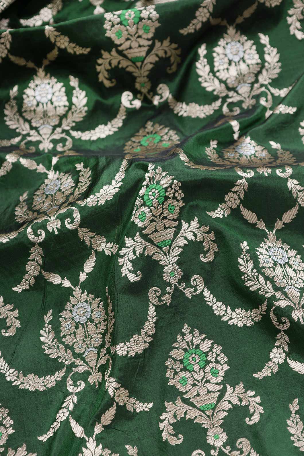 Close up of Green Dual Tone Banarasi Silk Saree with Zari Brocade on the body and Zari Border displaying folds