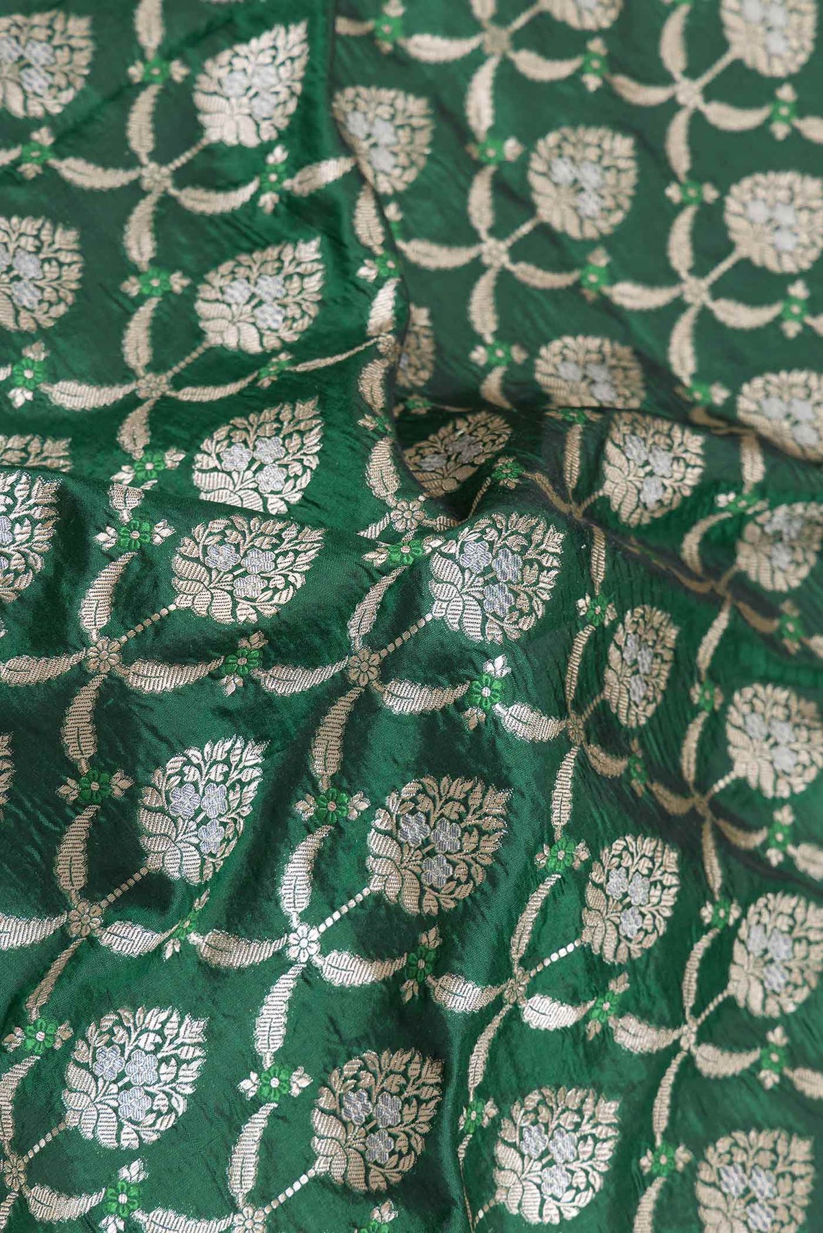 Close up of Green Dual Tone Banarasi Silk Saree with Zari Brocade on the body and Zari Border displaying folds