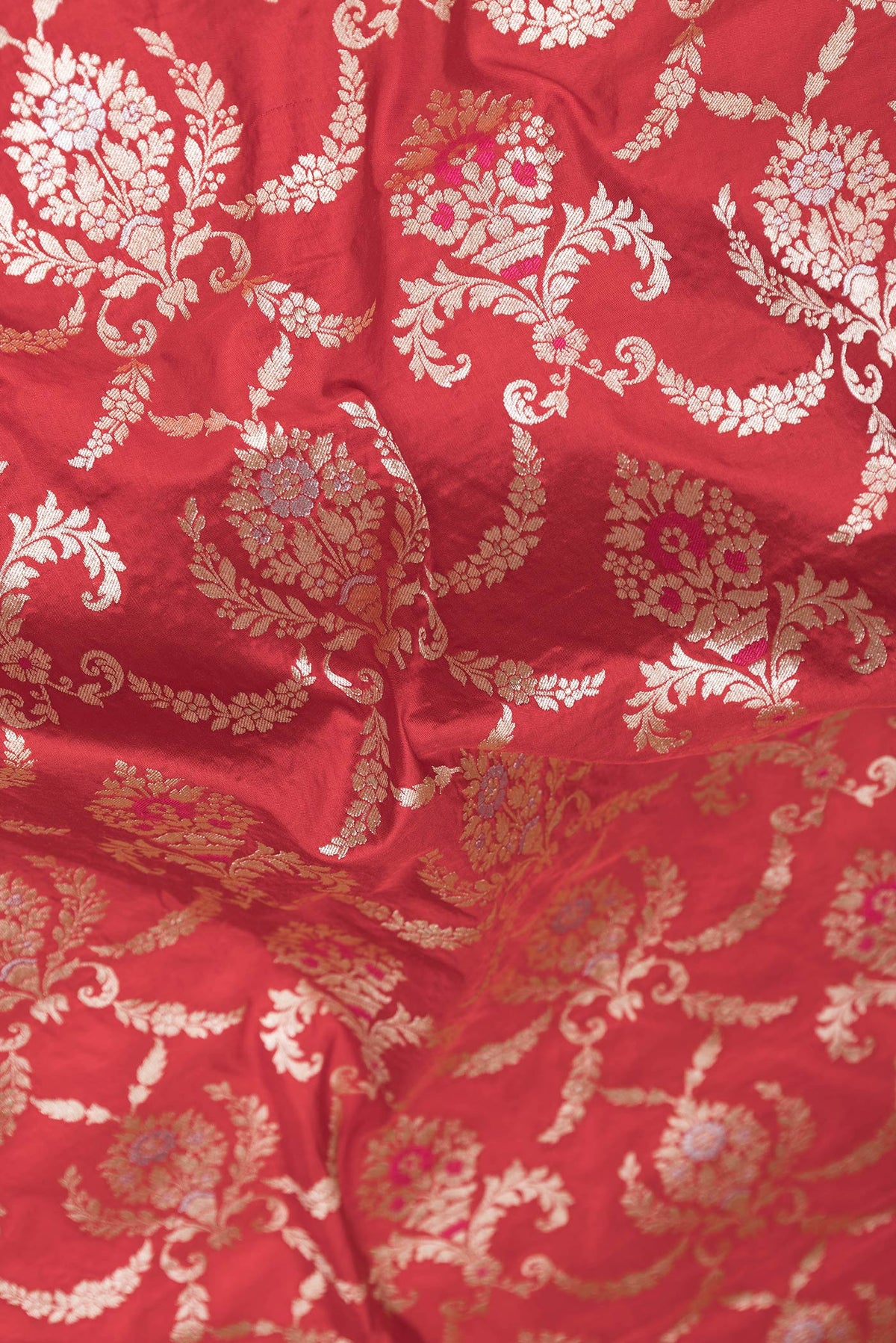 Close up of Red Dual Tone Banarasi Silk Saree with Zari Brocade on the body and Zari Border.  displaying folds