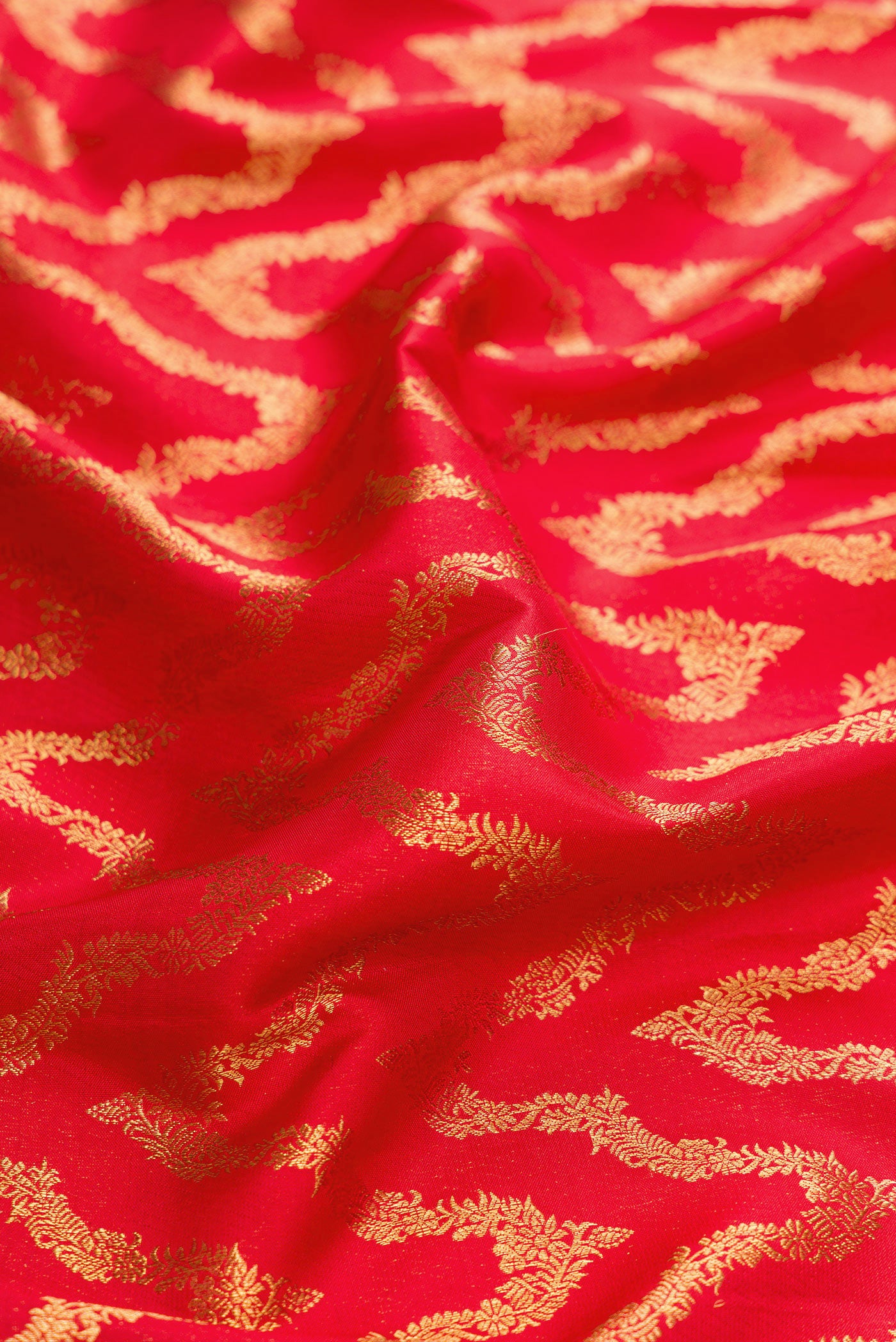 Close up of Red Dual Tone Kanchipuram Silk Saree with Zari Brocade on the body and Zari Border.  displaying folds