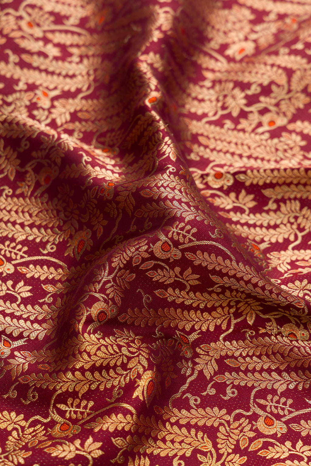 Close up of Brown Dual Tone Kanchipuram Silk Saree with Zari Brocade on the body and Zari Border.  displaying folds