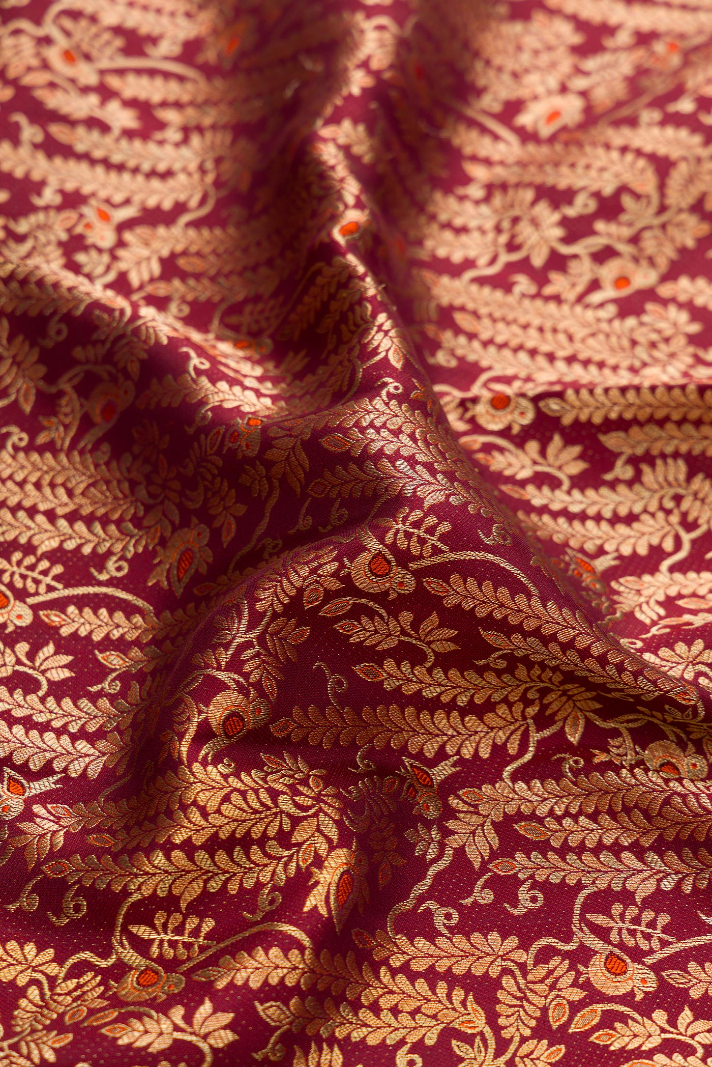 Close up of Brown Dual Tone Kanchipuram Silk Saree with Zari Brocade on the body and Zari Border.  displaying folds