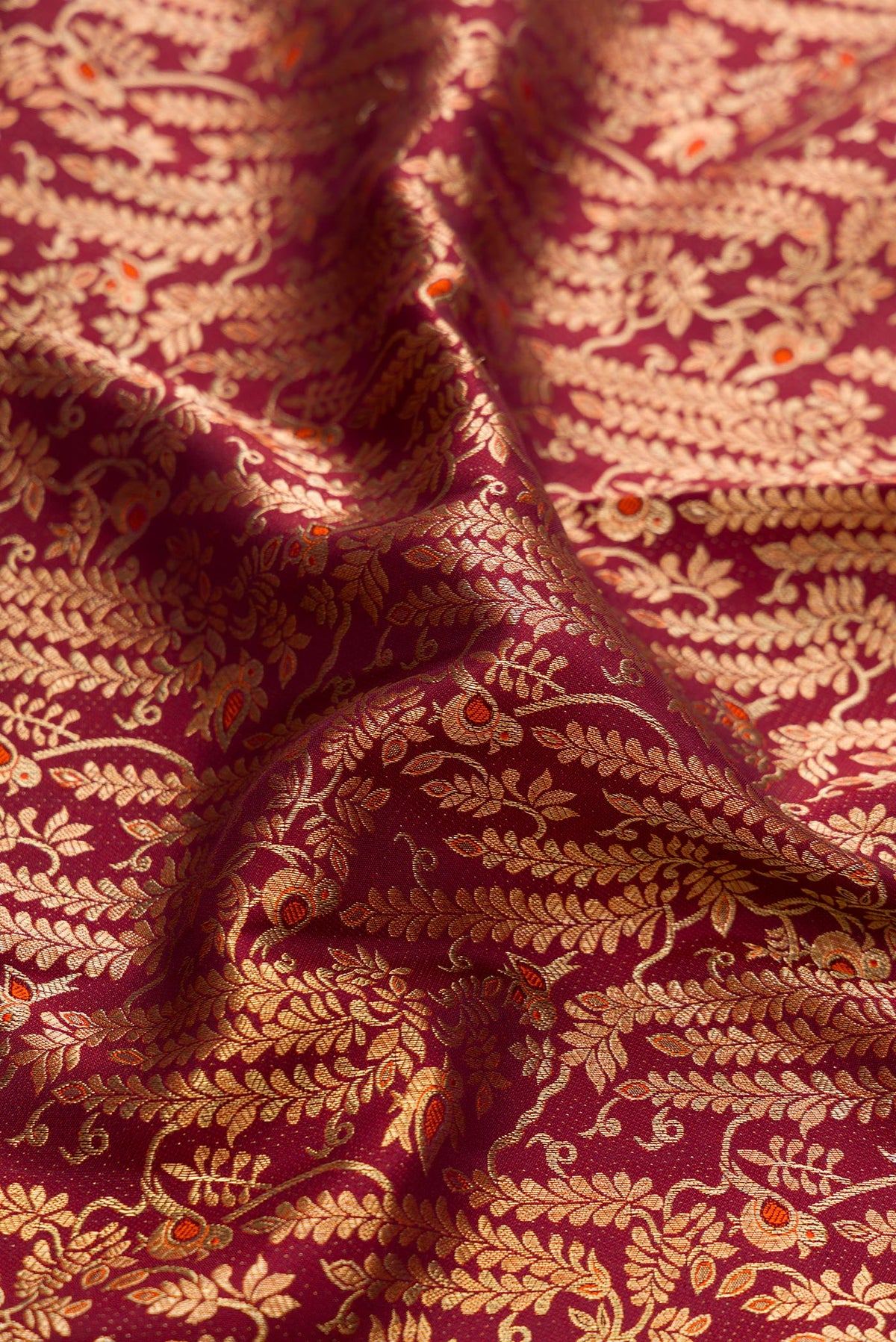 Close up of Brown Dual Tone Kanchipuram Silk Saree with Zari Brocade on the body and Zari Border.  displaying folds