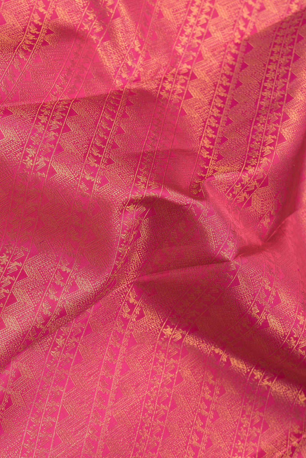 Close up of Pink Dual Tone Kanchipuram Silk Saree with Zari Brocade on the body and Zari Border.  displaying folds