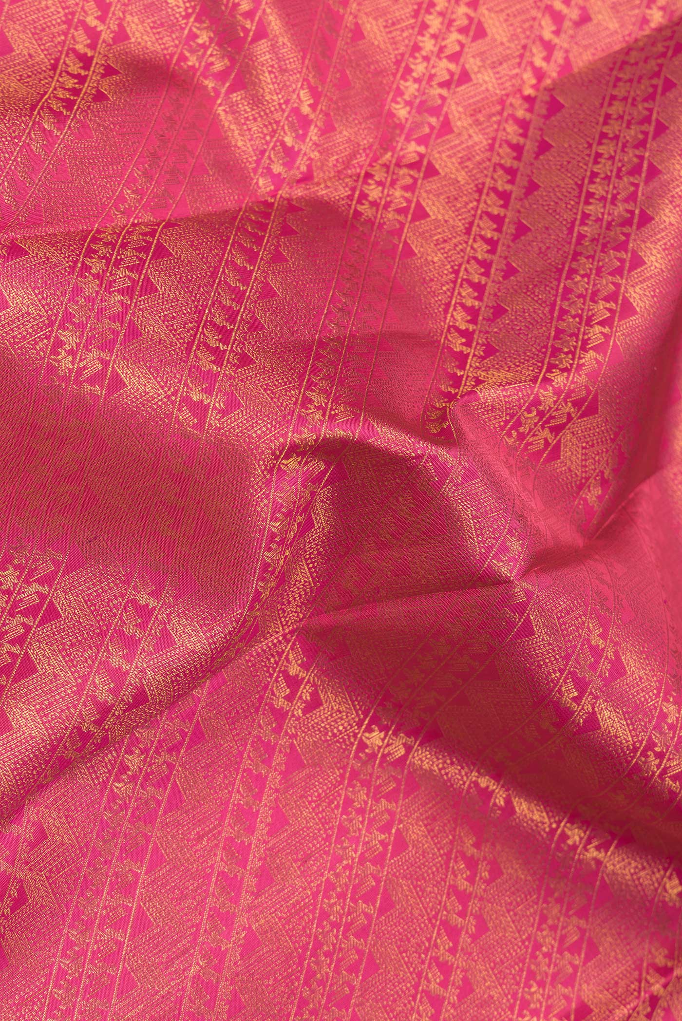 Close up of Pink Dual Tone Kanchipuram Silk Saree with Zari Brocade on the body and Zari Border.  displaying folds