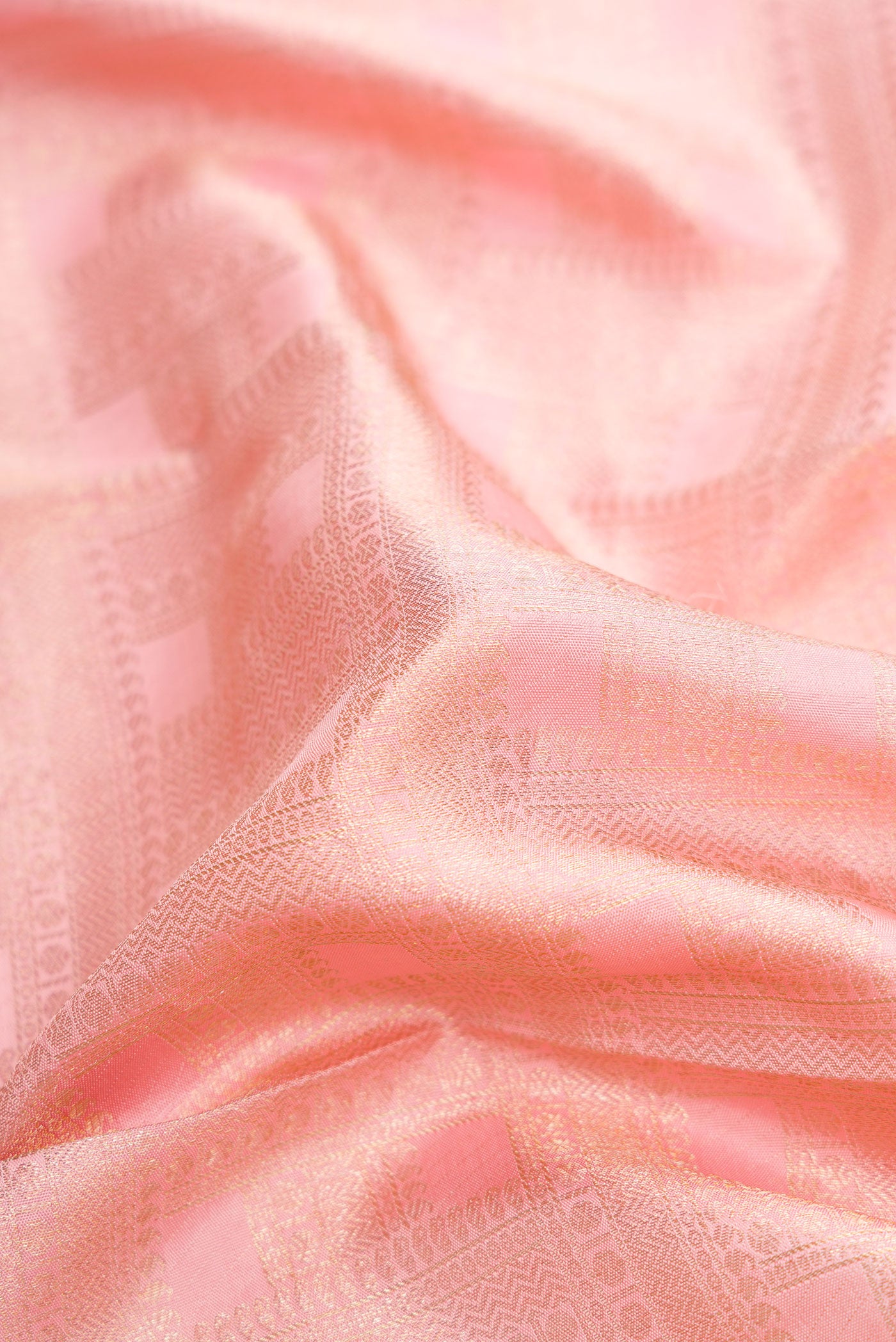 Close up of Pink Dual Tone Kanchipuram Silk Saree with Zari Brocade on the body and Zari Border.  displaying folds