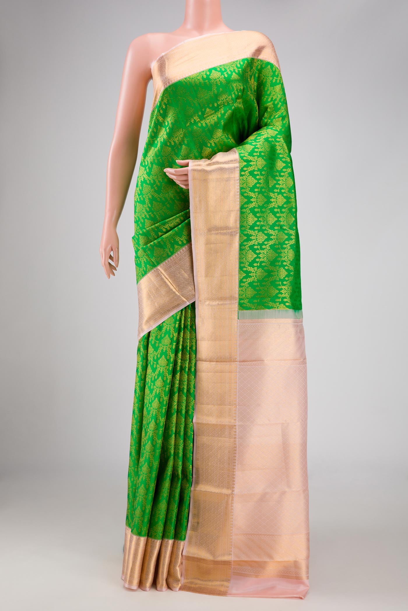 Parrot Green Dual Tone Kanchipuram Silk Saree with Zari Brocade on the body and Zari Border.  displayed on a mannequin