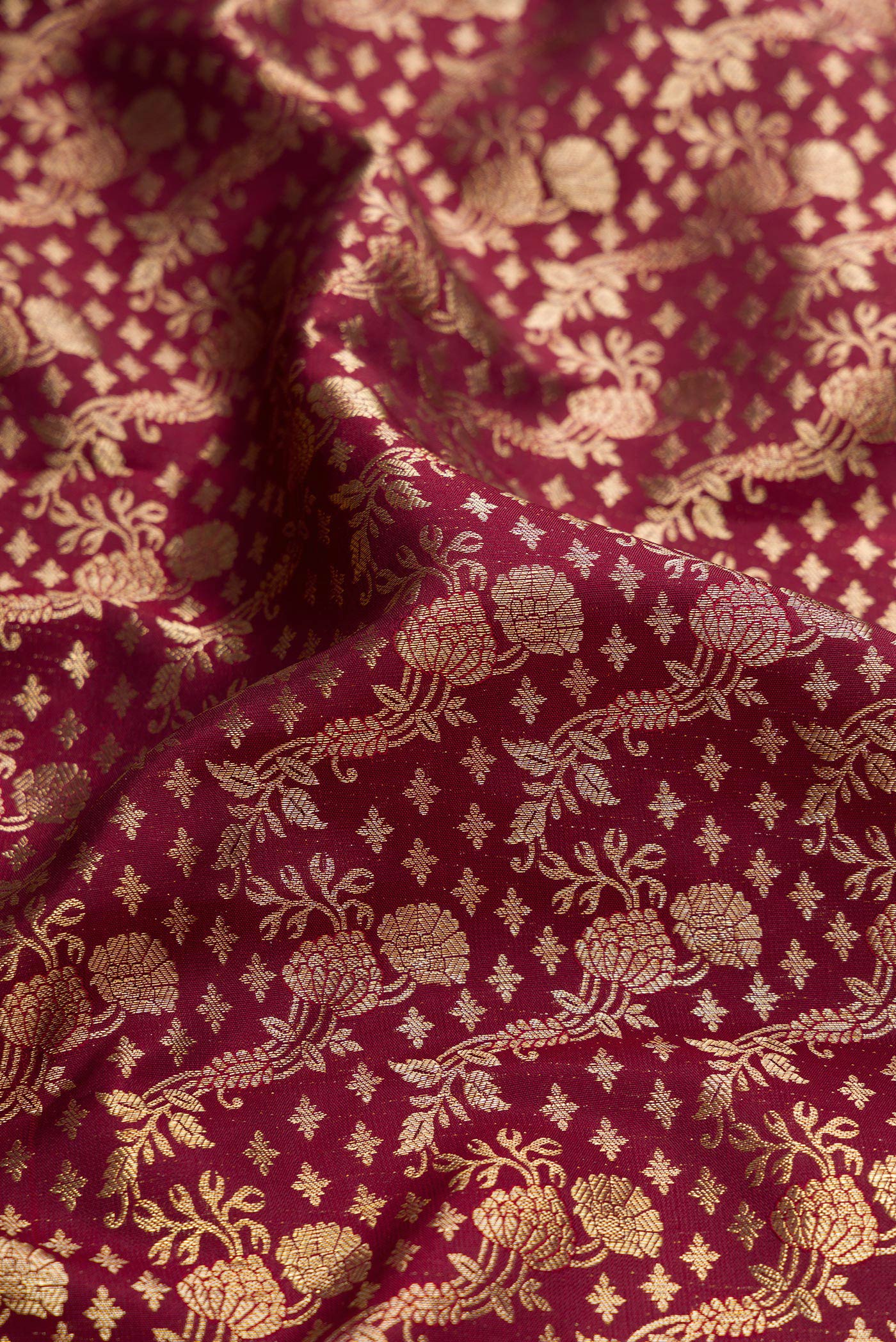 Close up of Coffee Brown Dual Tone Kanchipuram Silk Saree with Zari Brocade on the body and Zari Border.  displaying folds