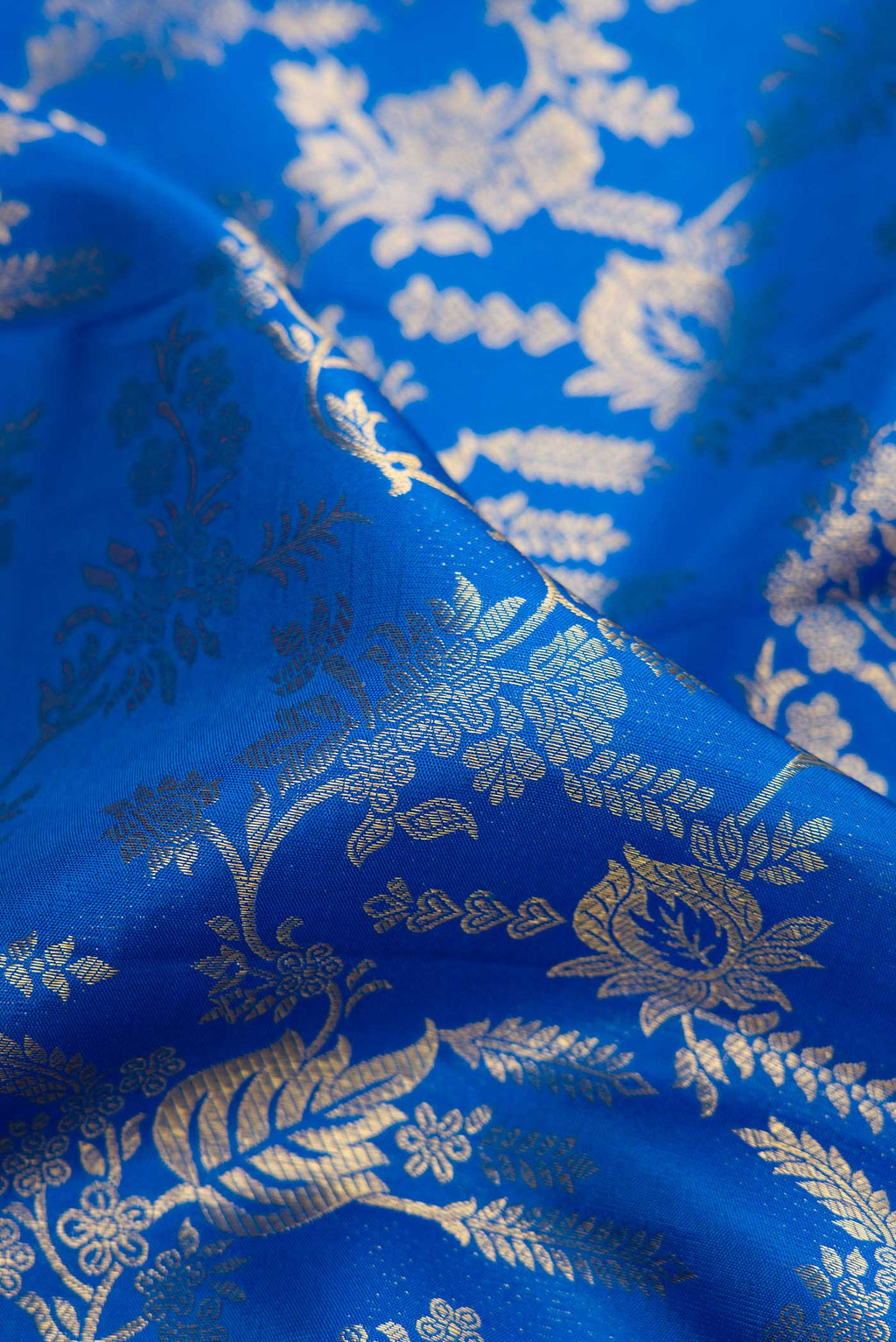 Close up of Royal Blue Dual Tone Kanchipuram Silk Saree with Zari Brocade on the body and Zari Border.  displaying folds