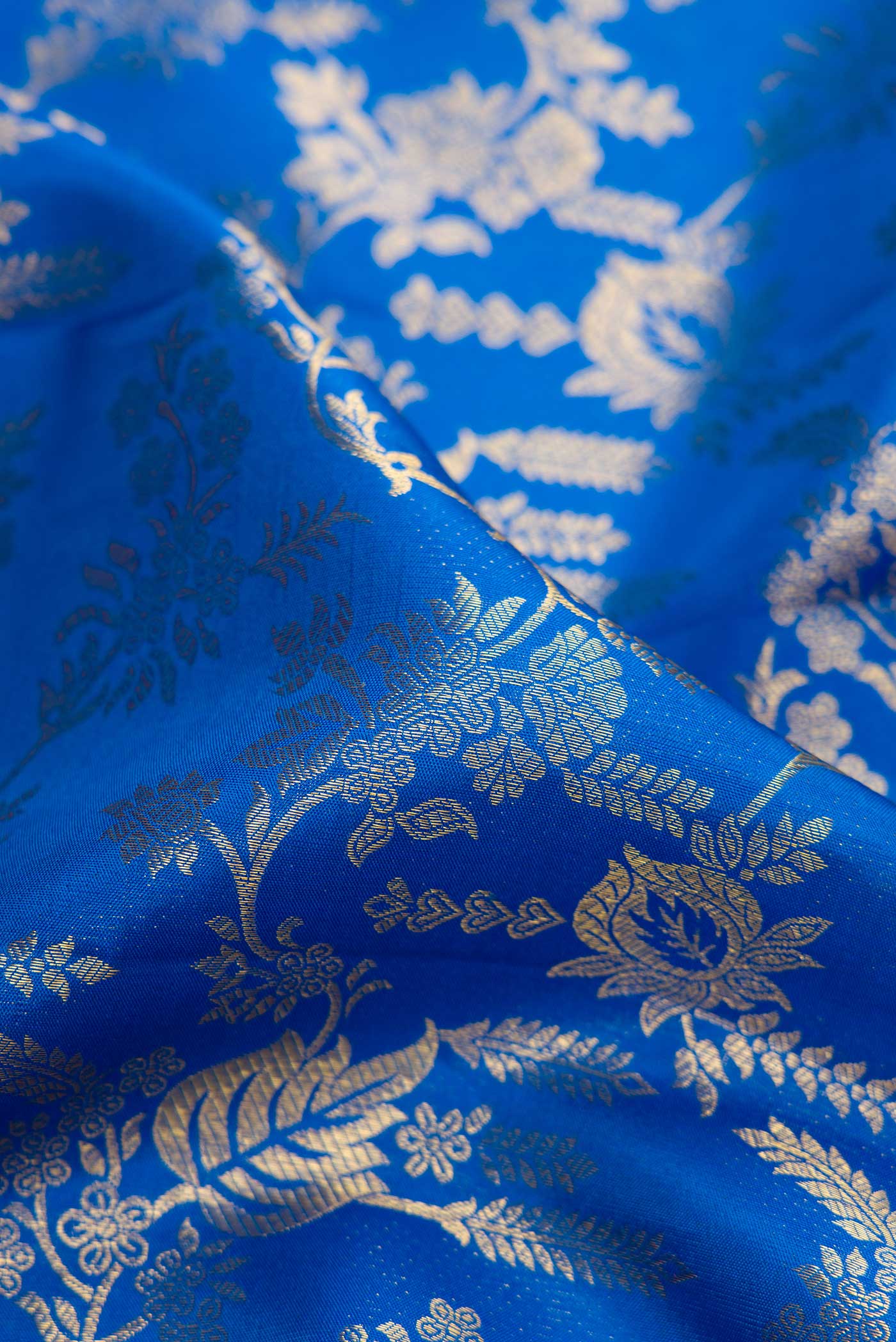 Close up of Royal Blue Dual Tone Kanchipuram Silk Saree with Zari Brocade on the body and Zari Border.  displaying folds