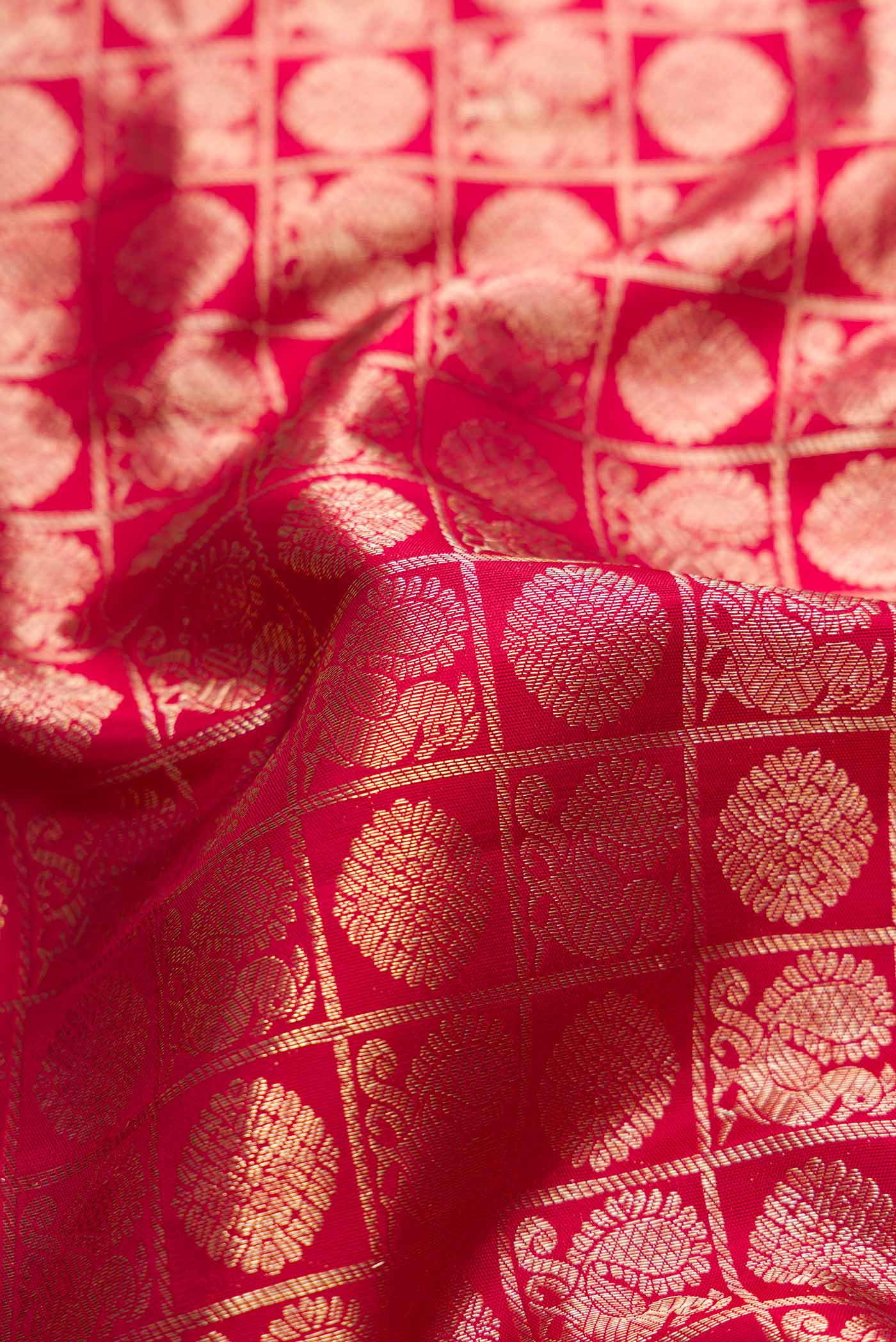 Close up of Maroon Dual Tone Kanchipuram Silk Saree with Zari Brocade on the body and Zari Border.  displaying folds