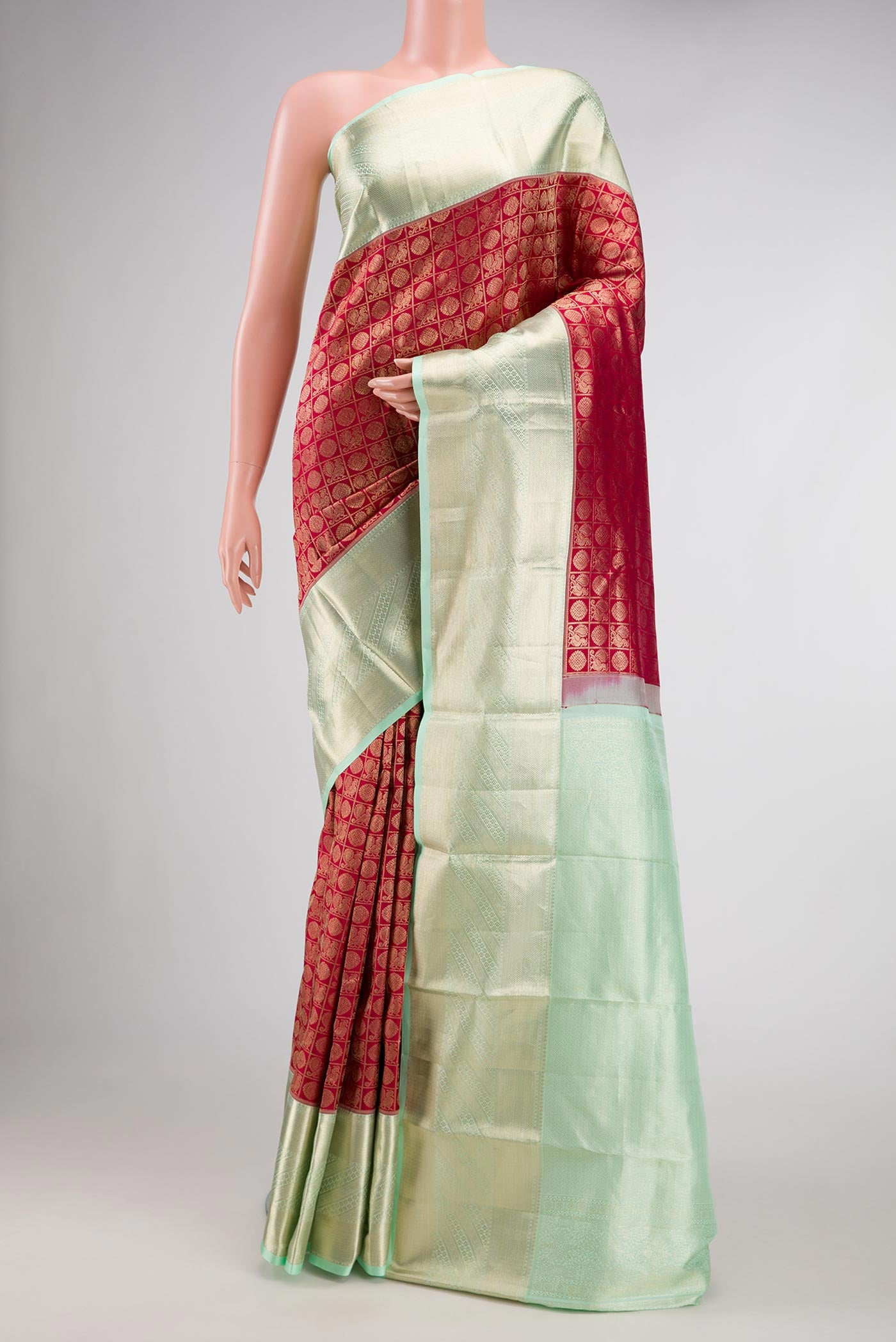 Maroon Dual Tone Kanchipuram Silk Saree with Zari Brocade on the body and Zari Border.  displayed on a mannequin