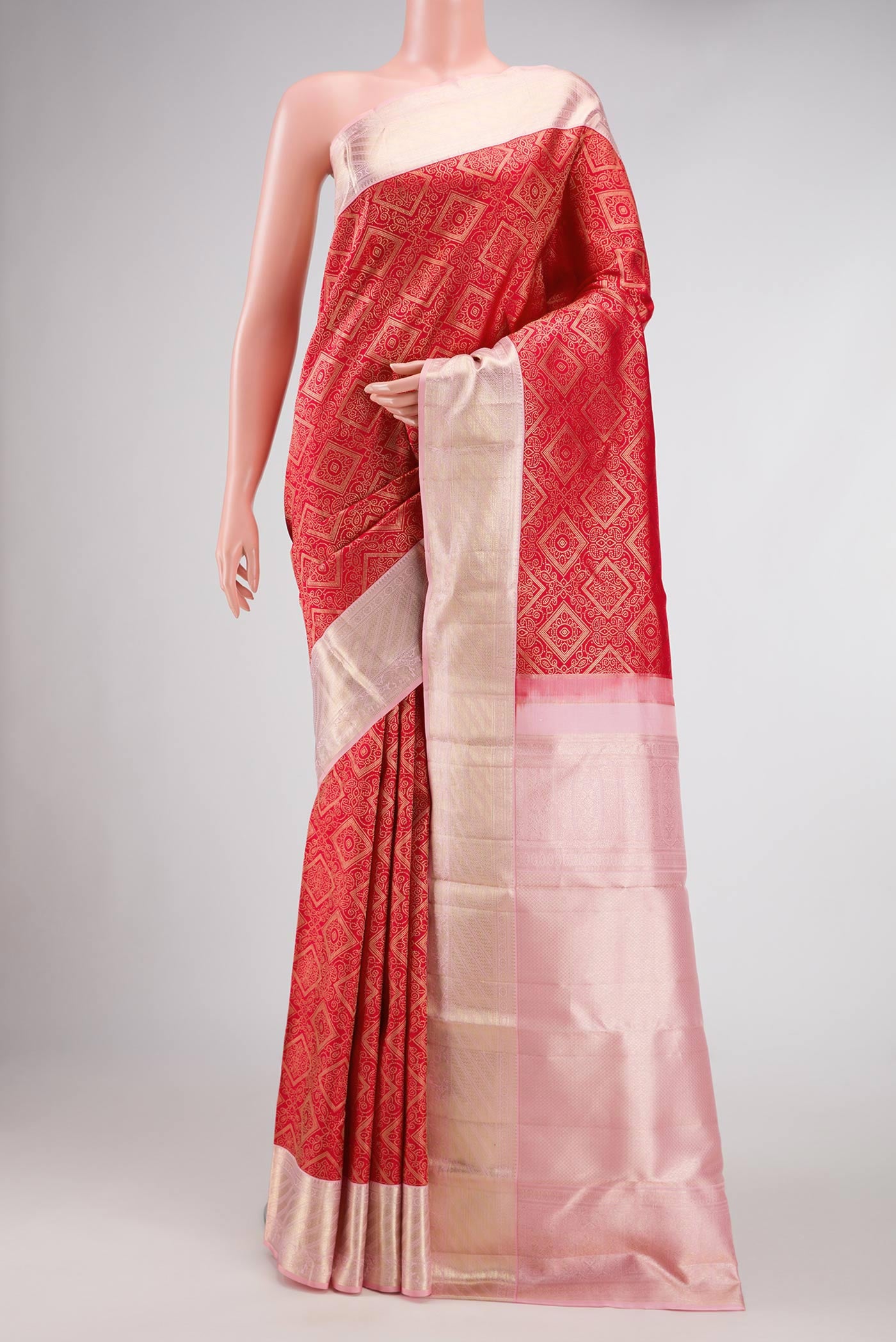 Red Dual Tone Kanjivaram Silk Saree with Zari Brocade on the body and Zari Border.  displayed on a mannequin