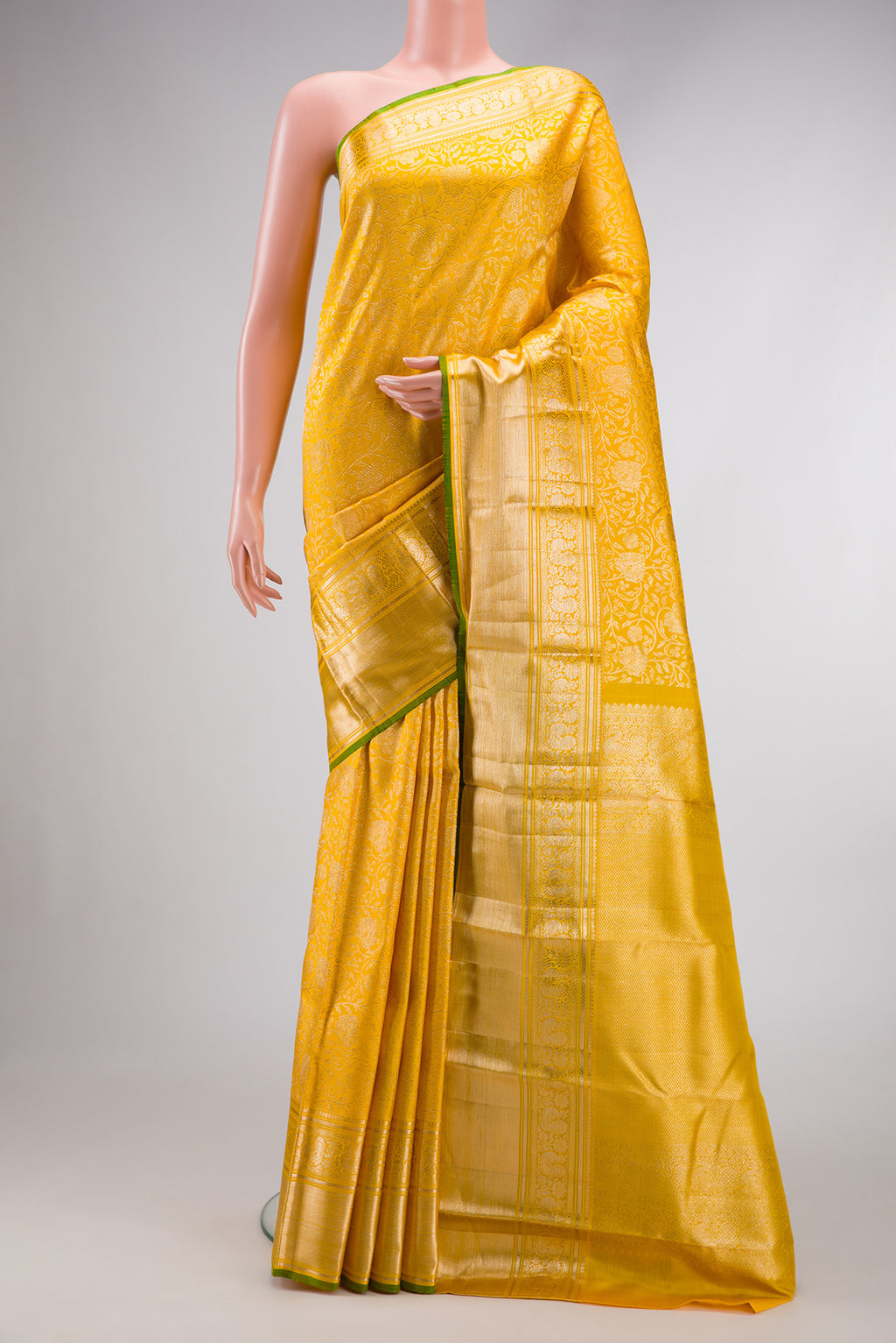 Yellow Dual Tone Kanchipuram Silk Saree with Zari Brocade on the body and Zari Border.  displayed on a mannequin