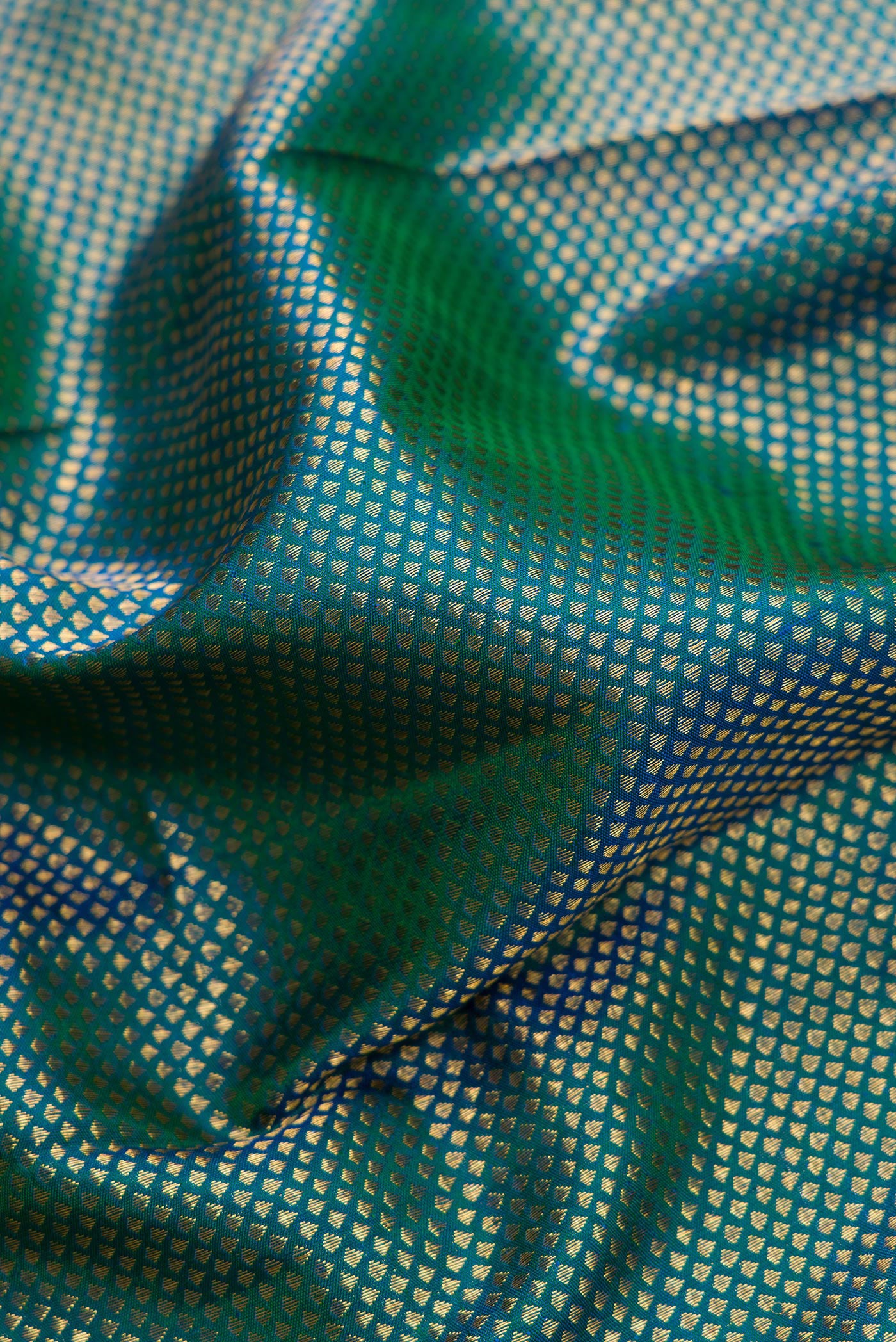 Close up of Peacock Blue Dual Tone Kanchipuram Silk Saree with Zari Brocade on the body and Zari Border.  displaying folds