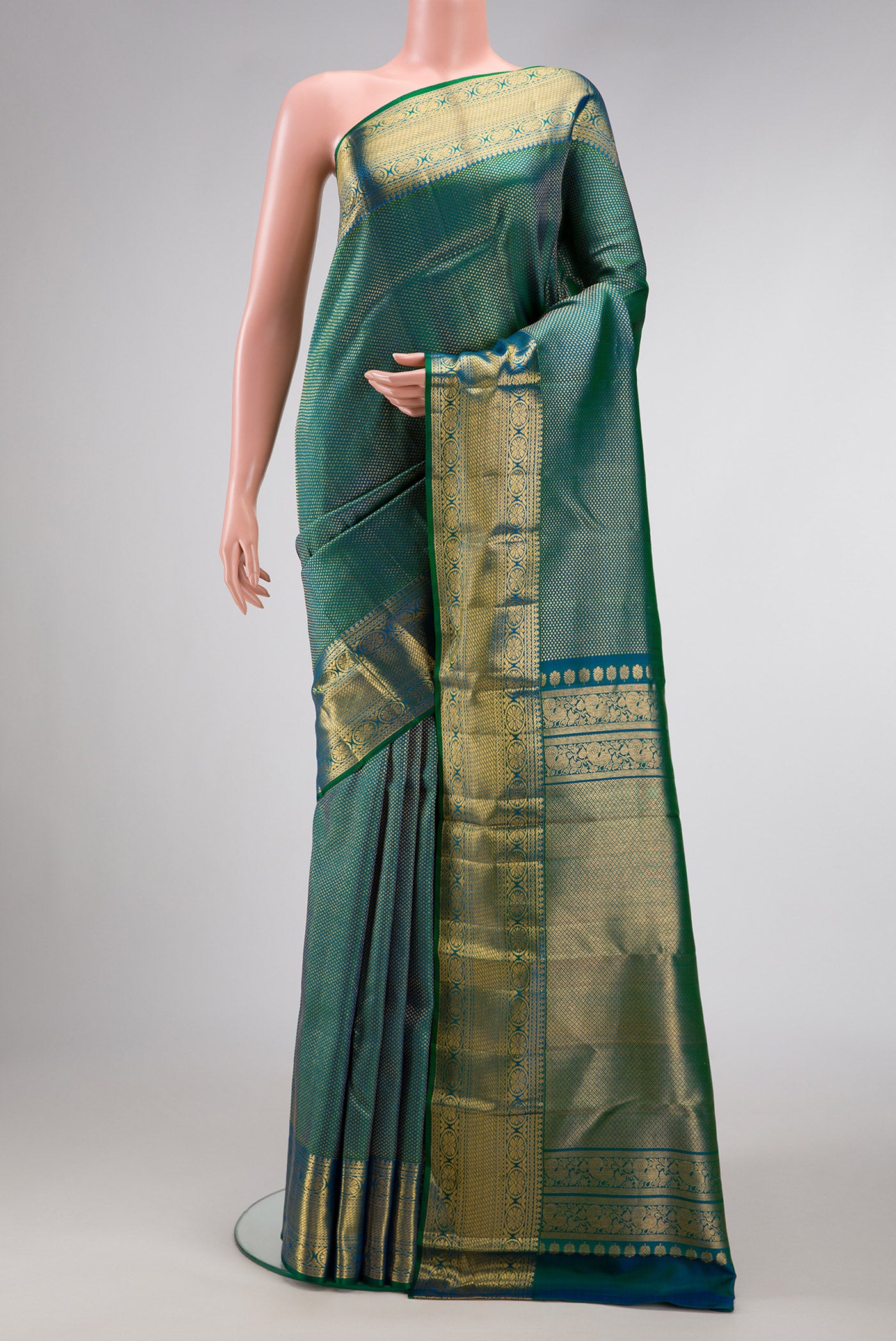 Peacock Blue Dual Tone Kanchipuram Silk Saree with Zari Brocade on the body and Zari Border.  displayed on a mannequin