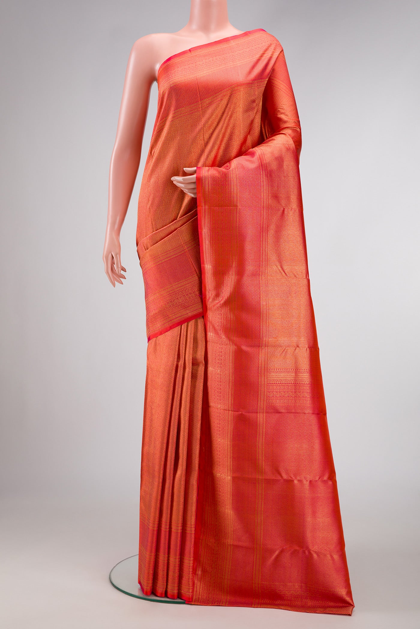Coral Dual Tone Kanchipuram Silk Saree with Zari Brocade on the body and Zari Border.  displayed on a mannequin