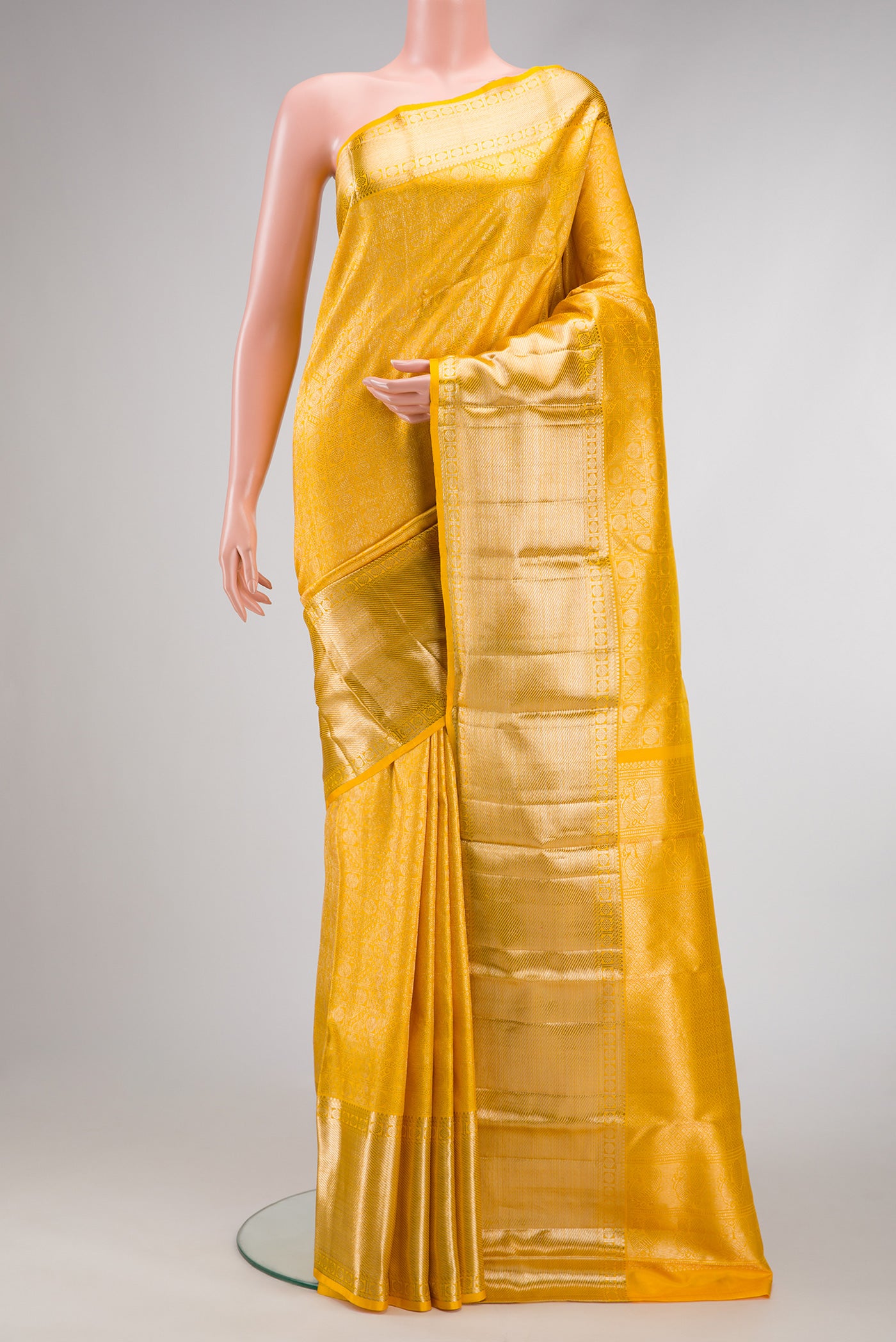Yellow Dual Tone Kanchipuram Silk Saree with Zari Brocade on the body and Fancy Border.  displayed on a mannequin