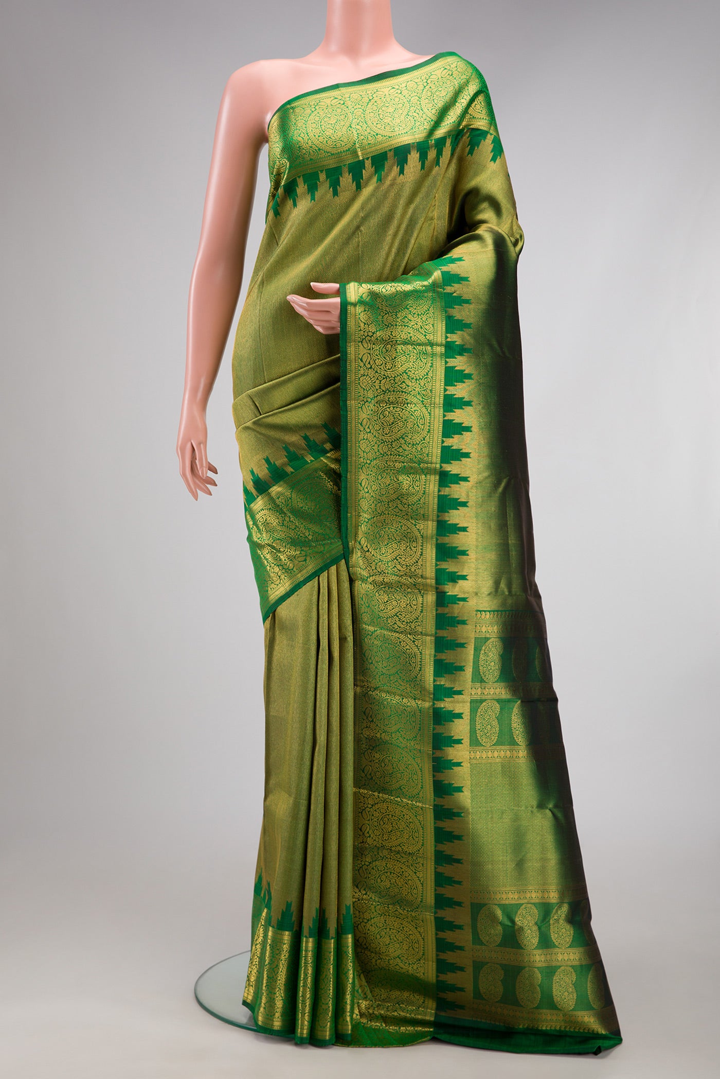 Green Kanchipuram Silk Saree with Zari Brocade on the body and Zari Border.  displayed on a mannequin