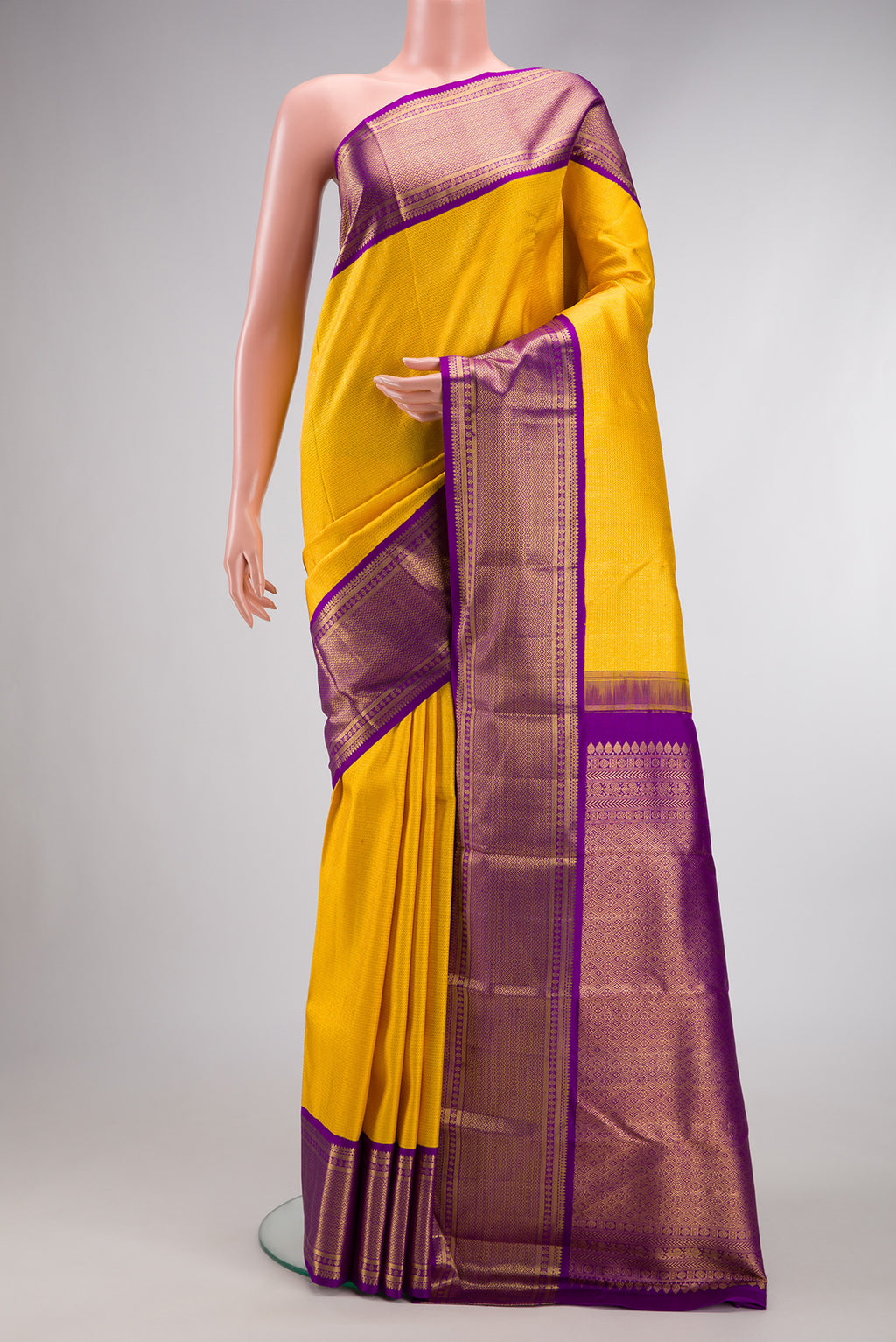 Yellow Dual Tone Kanchipuram Silk Saree with Zari Brocade on the body and Zari Border.  displayed on a mannequin