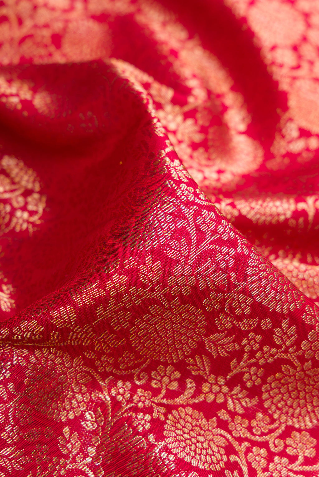 Close up of Maroon Dual Tone Kanchipuram Silk Saree with Zari Brocade on the body and Zari Border.  displaying folds