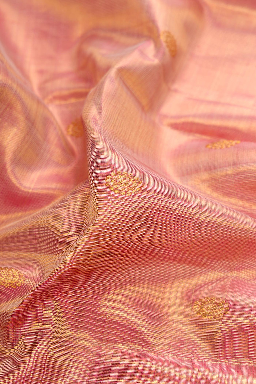 Close up of Rose Gold Dual Tone Kanchipuram Tissue Silk Saree with Zari Brocade on the body and Zari Border.  displaying folds