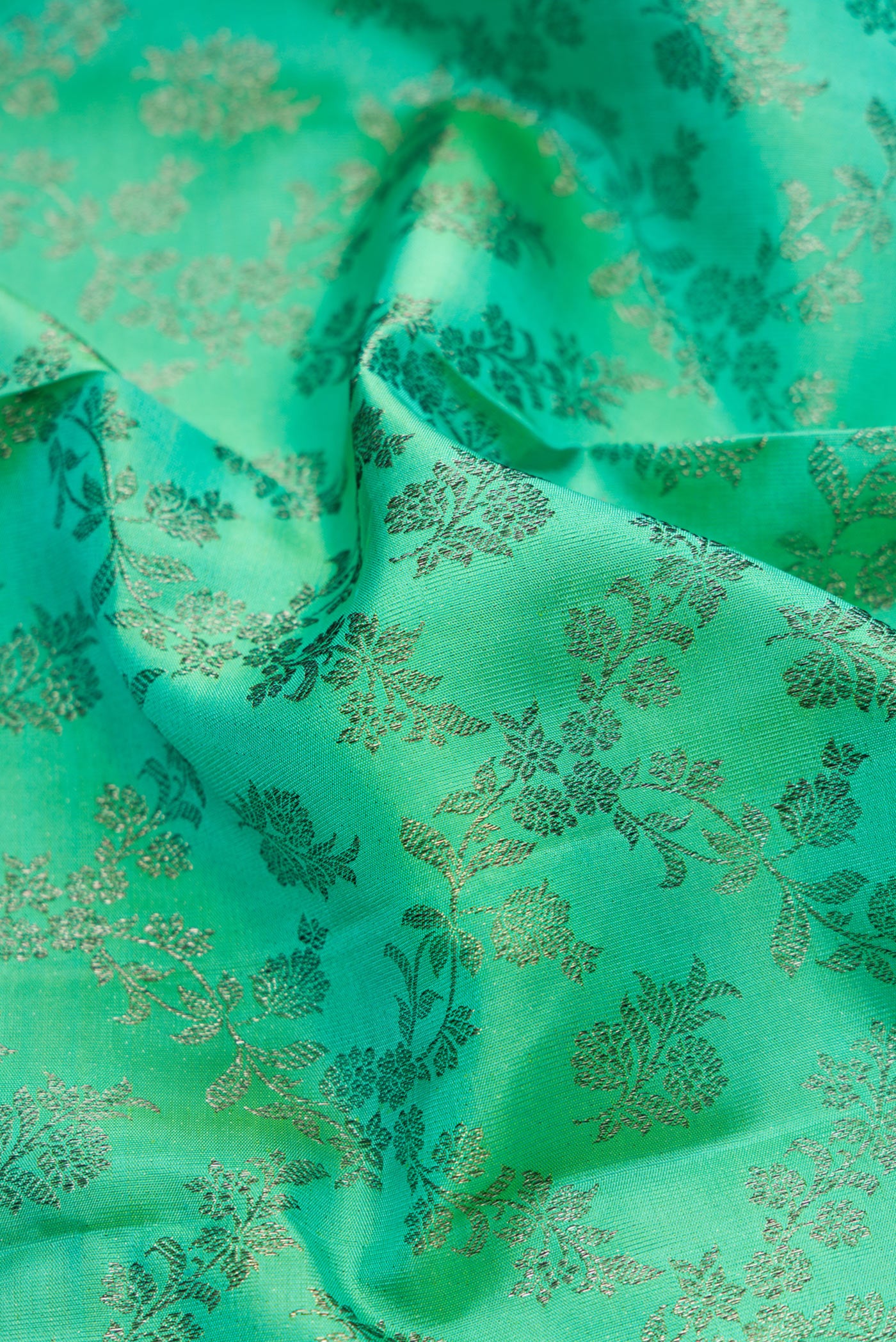 Close up of Sea Green Dual Tone Kanjivaram Silk Saree with Zari Brocade on the body and Zari Border.  displaying folds