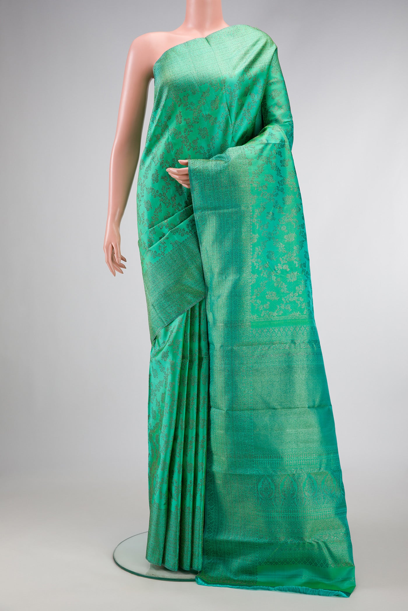 Sea Green Dual Tone Kanjivaram Silk Saree with Zari Brocade on the body and Zari Border.  displayed on a mannequin