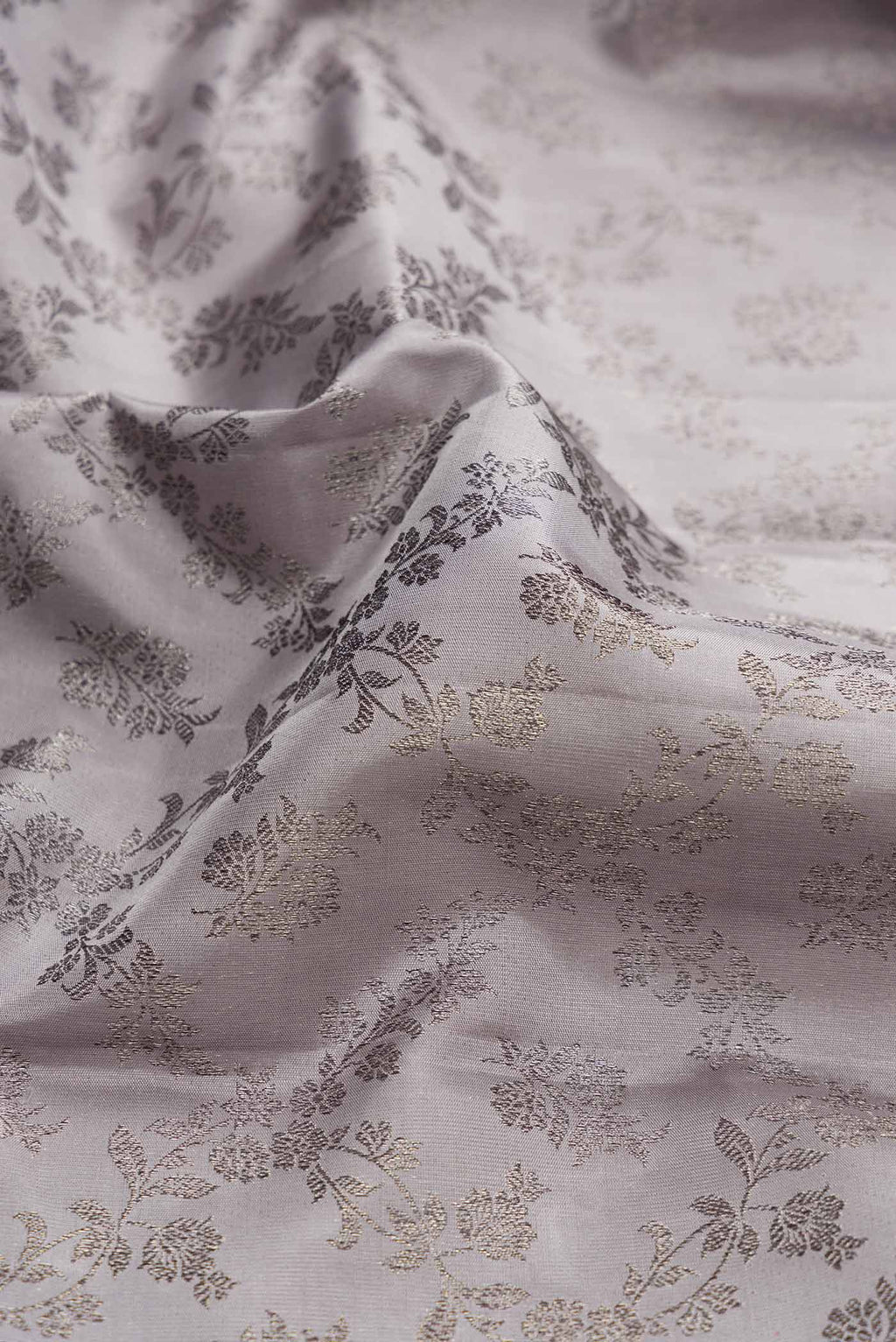 Close up of Grey Dual Tone Kanchipuram Silk Saree with Zari Brocade on the body and Zari Border displaying folds
