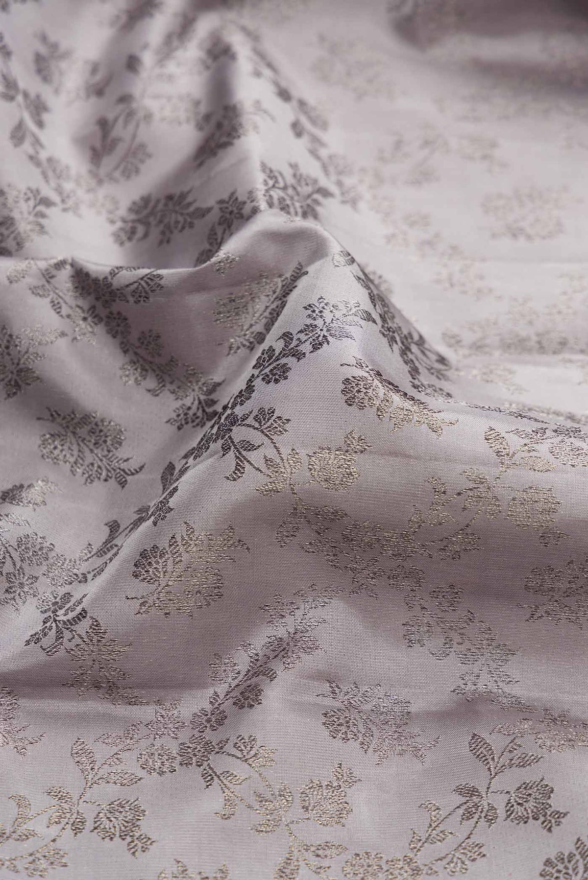 Close up of Grey Dual Tone Kanchipuram Silk Saree with Zari Brocade on the body and Zari Border displaying folds