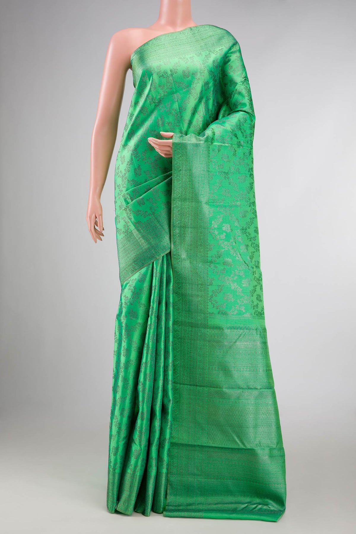 Green Dual Tone Kanchipuram Silk Saree with Zari Brocade on the body and Zari Border displayed on a mannequin