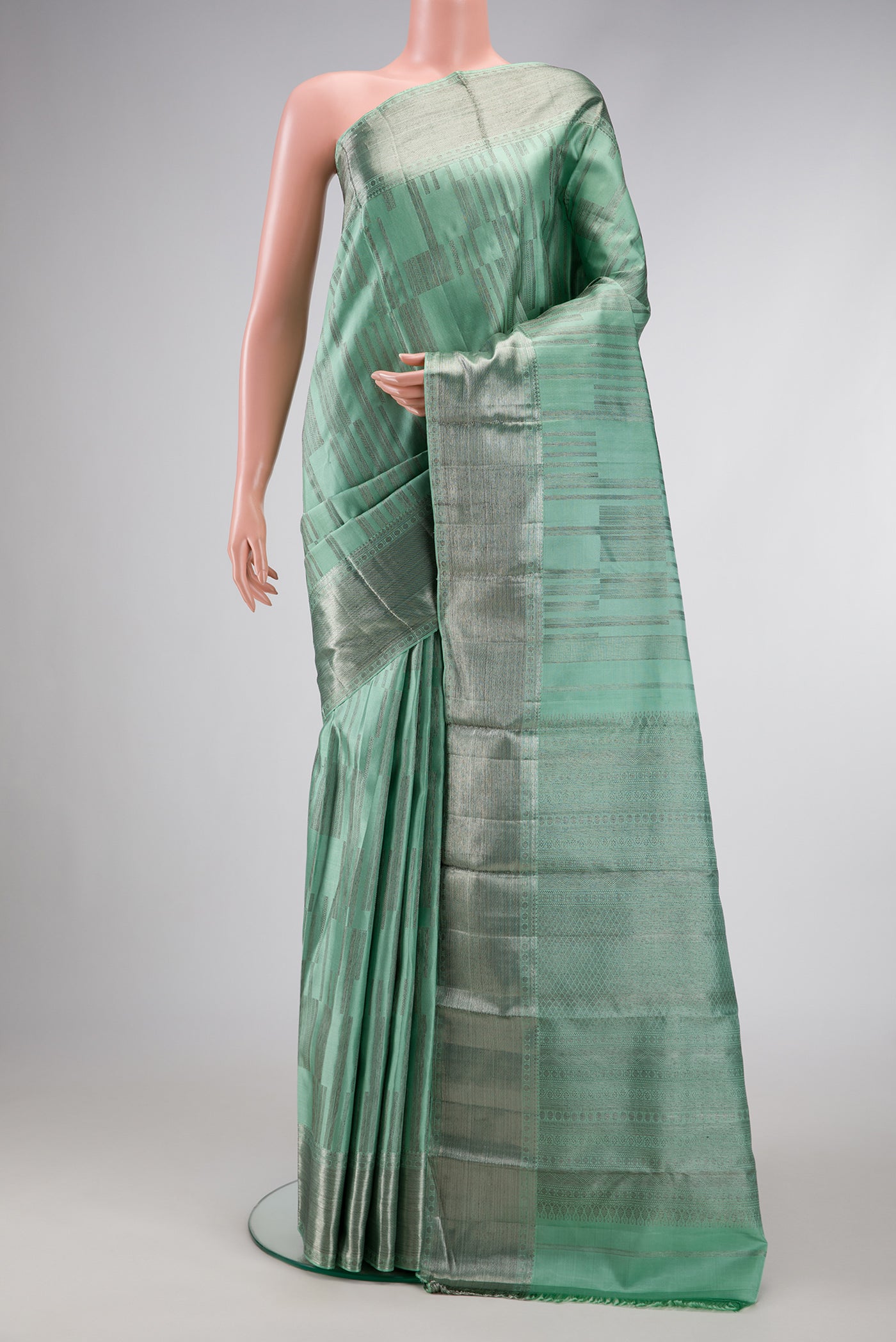 Light Green Dual Tone Kanjivaram Silk Saree with Zari Brocade on the body and Zari Border.  displayed on a mannequin