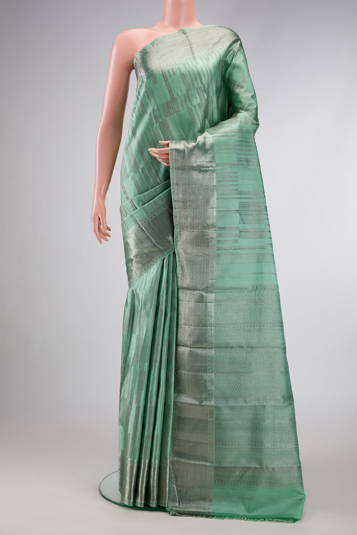 Light Green Dual Tone Kanjivaram Silk Saree with Zari Brocade on the body and Zari Border.  displayed on a mannequin
