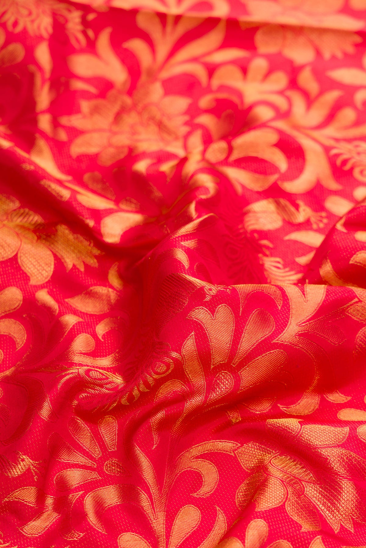Close up of Red Dual Tone Kanchipuram Silk Saree with Zari Brocade on the body and Zari Border.  displaying folds