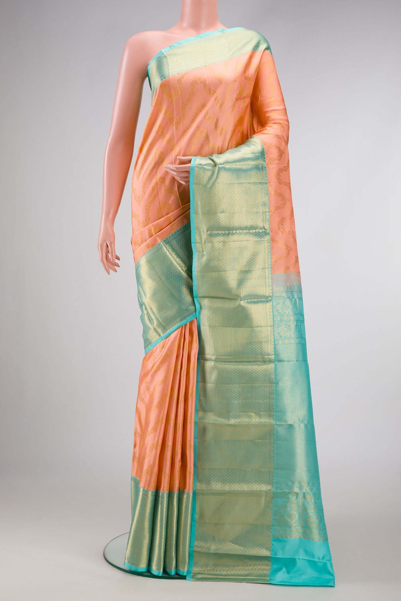 Peach Dual Tone Kanjivaram Silk Saree with Zari Brocade on the body and Zari Border.  displayed on a mannequin