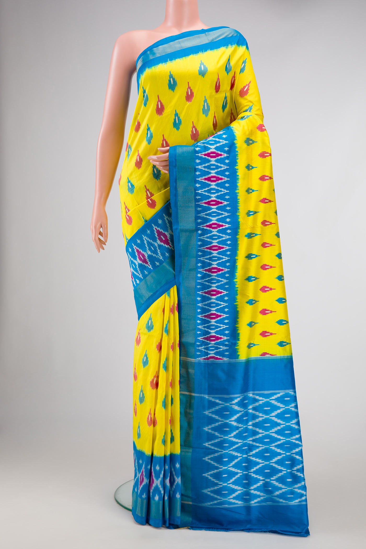 Lemon Yellow Dual Tone Double Ikat Saree with Ikat Print on the body and Ikat Border.  displayed on a mannequin