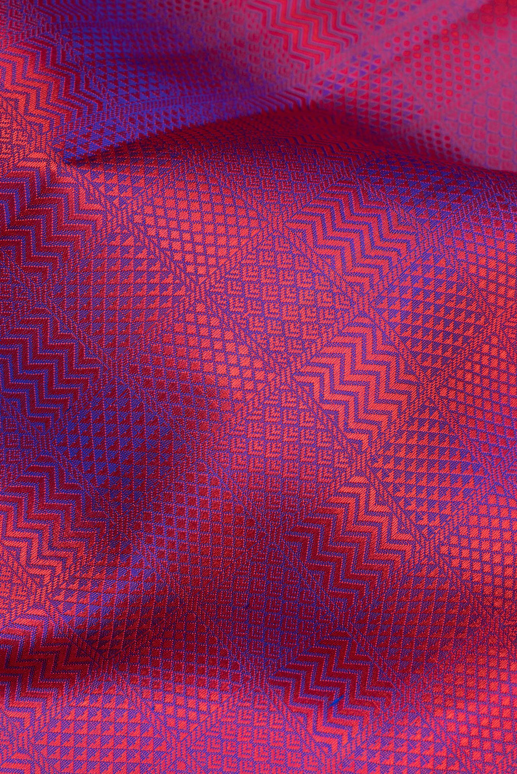 Close up of Pure Silk Purple Dual Tone Kanchipuram Saree with Jacquard design on the body and Thread Border.  displaying folds