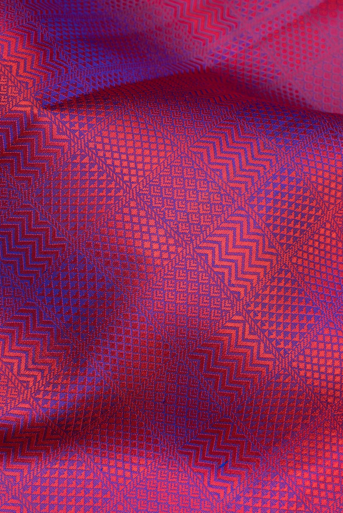 Close up of Pure Silk Purple Dual Tone Kanchipuram Saree with Jacquard design on the body and Thread Border.  displaying folds