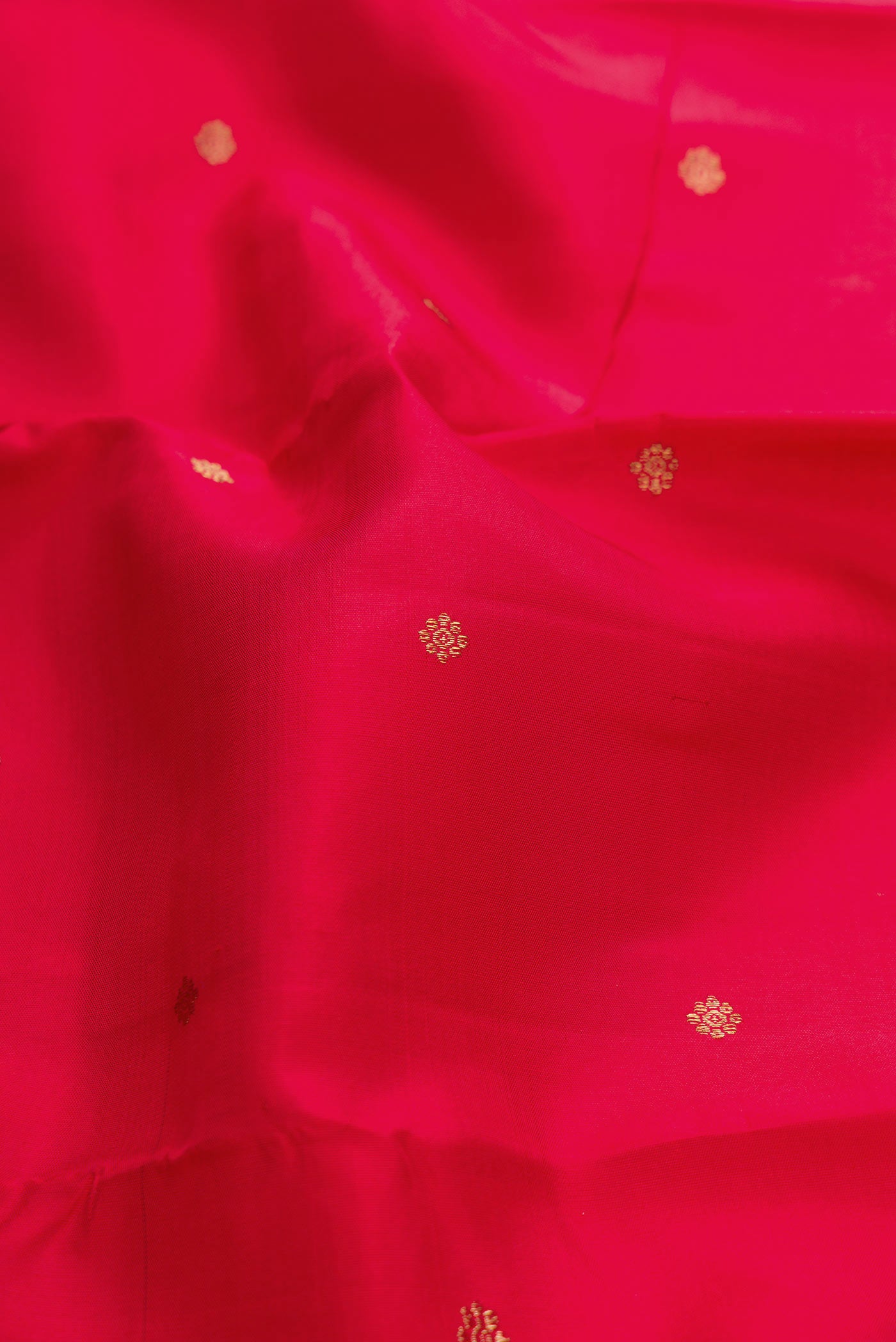 Close up of Pure Silk Pure Zari Pink Kanchipuram Saree with Zari Butta on the body and Zari Border displaying folds