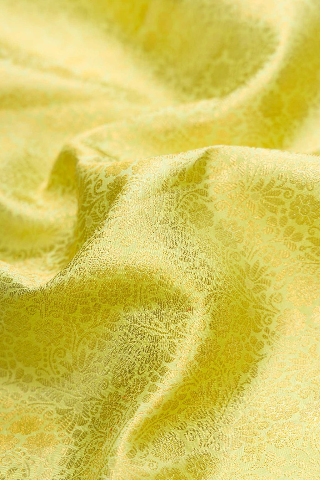 Close up of Parrot Green Dual Tone Kanchipuram Silk Saree with Zari Brocade on the body and Zari Border.  displaying folds