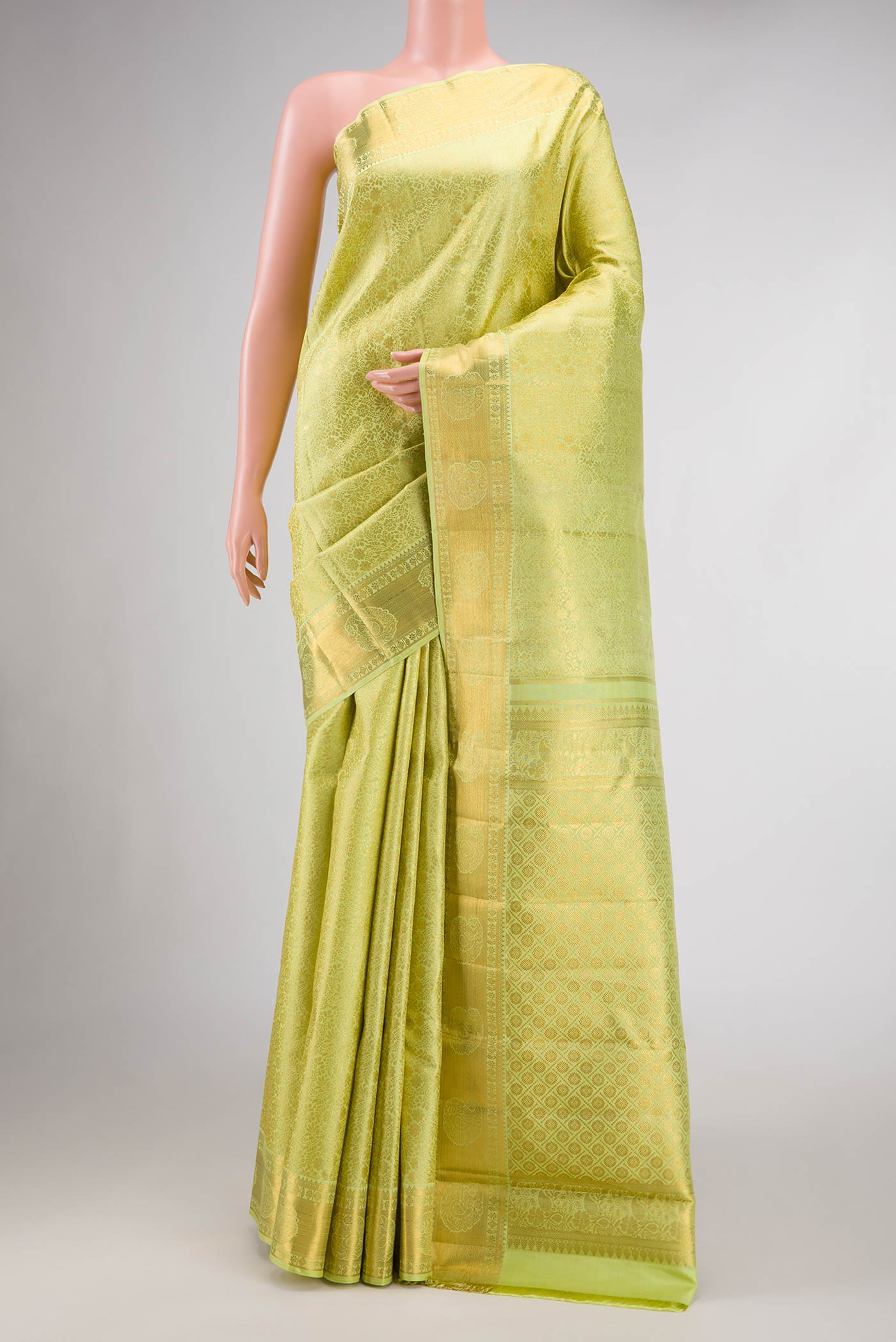 Parrot Green Dual Tone Kanchipuram Silk Saree with Zari Brocade on the body and Zari Border.  displayed on a mannequin