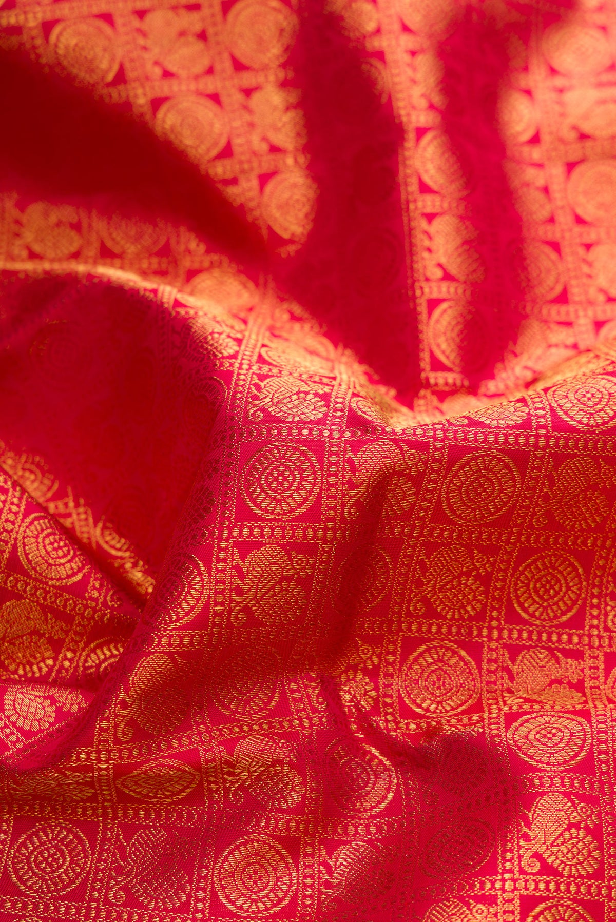 Close up of Pure Silk Pure Zari Maroon Dual Tone Kanjivaram Saree with Zari Brocade on the body and Fancy Border.  displaying folds