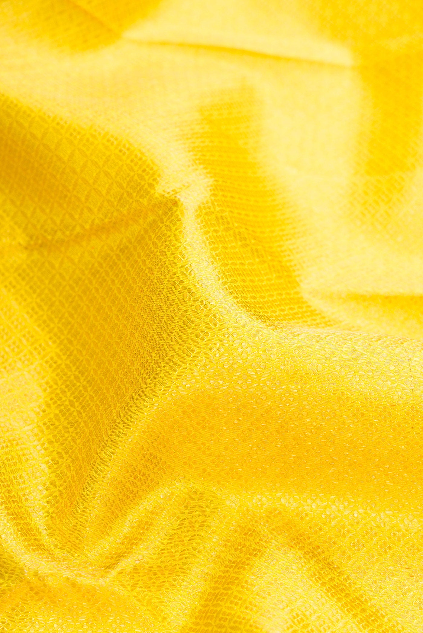 Close up of Pure Silk Pure Zari Yellow Dual Tone Kanjivaram Saree with Zari Brocade on the body and Zari Border.  displaying folds